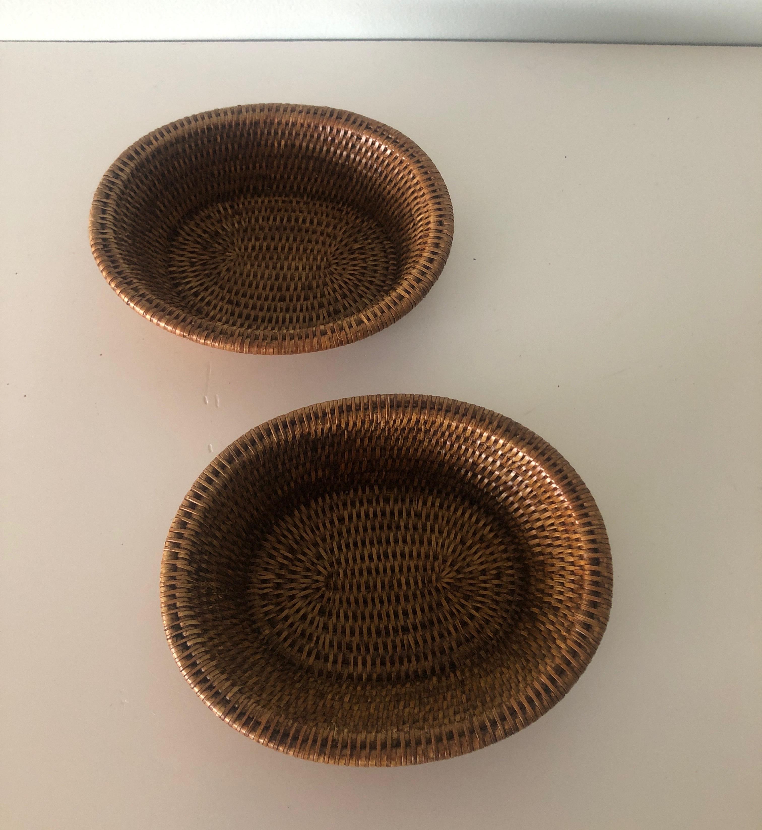Set of (2) woven rattan oval baskets.
Size: 8.5