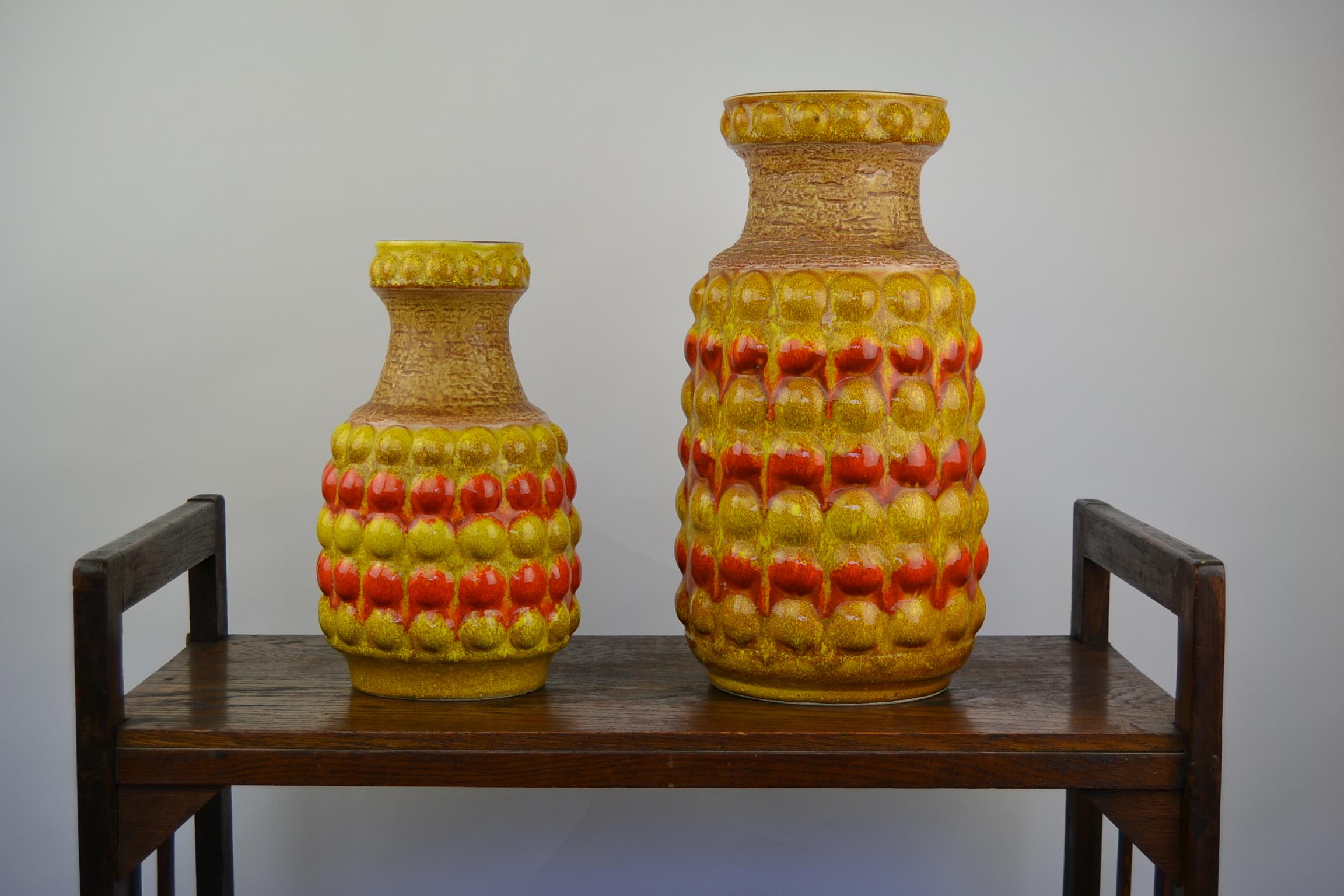 Set of 2 Art Pottery Vases - Fat Lava Vases. 
Bubbled Vases with the colors Yellow and Orange. 
These Ceramic Vases date from the 1960s and were made in Western Germany by Bay Keramic. 
They are 11,81 inch and 15,74 inch Heigh --- 30 cm and 40 cm