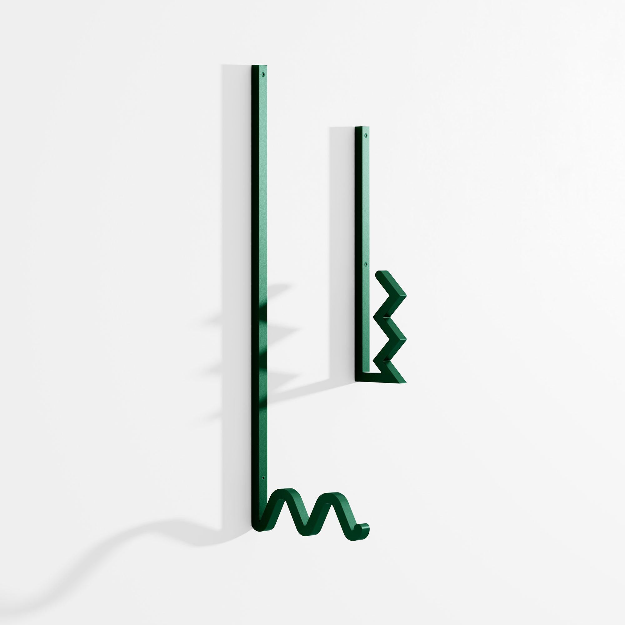 Set of 2 zag coat hanger by Bling Desing Studio.
Dimensions: H 26,5 x L 6, H 41 x L 14,2.
Materials: green textured metal.


Zag is a family of coat hooks whose shapes are inspired by barrettes and pins. Each Zag is like an imaginary letter