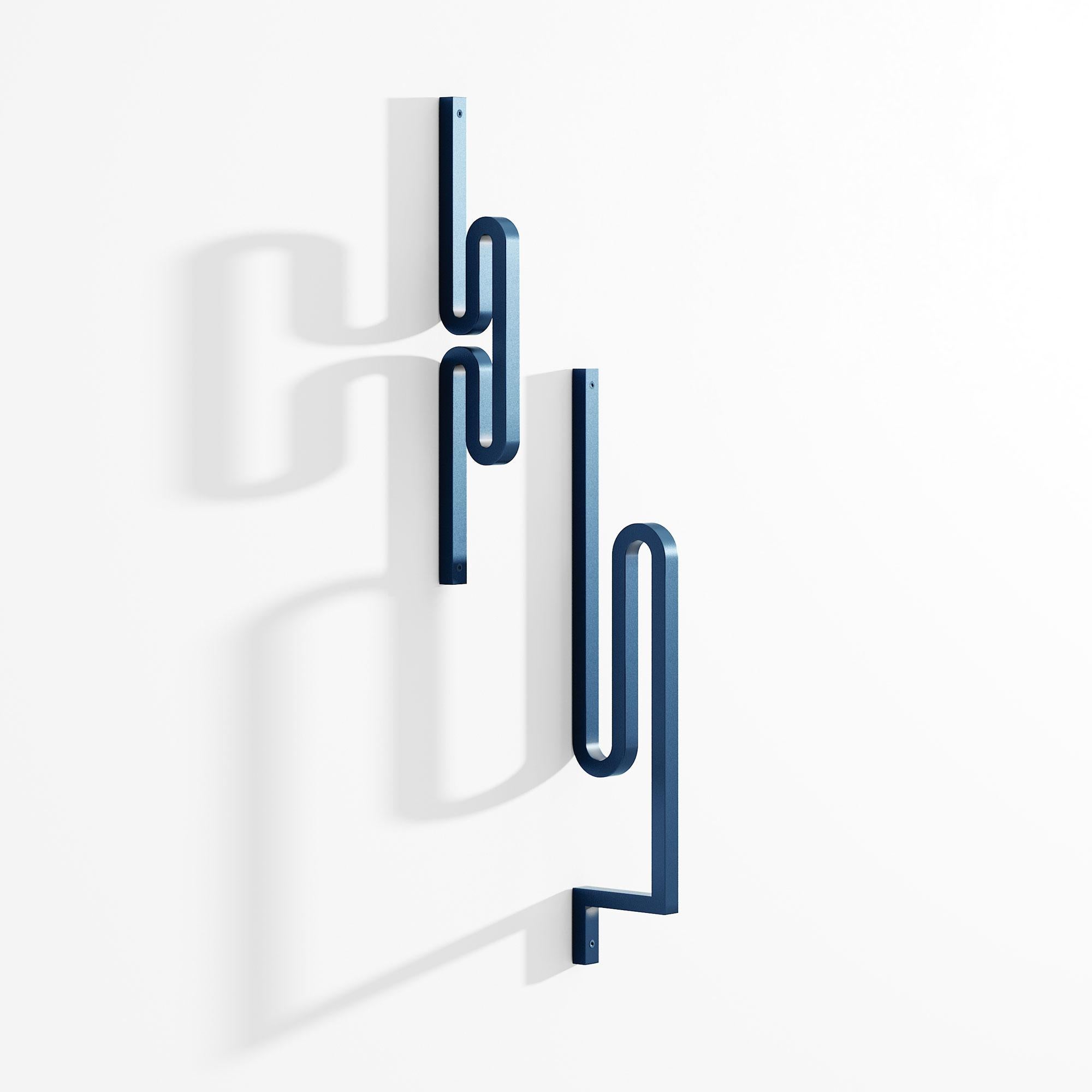 Set of 2 Zag coat hanger by Bling Desing Studio.
Dimensions: H26,5, x L5 - H38 x L8.
Materials: blue textured metal


Zag is a family of coat hooks whose shapes are inspired by barrettes and pins. Each Zag is like an imaginary letter that