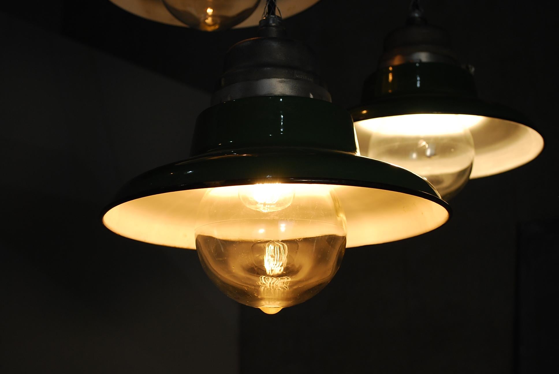 Set of 20 .. only 8 left    salvaged industrial fixtures with green enamel shades and blown glass protector globe. Measure: 14