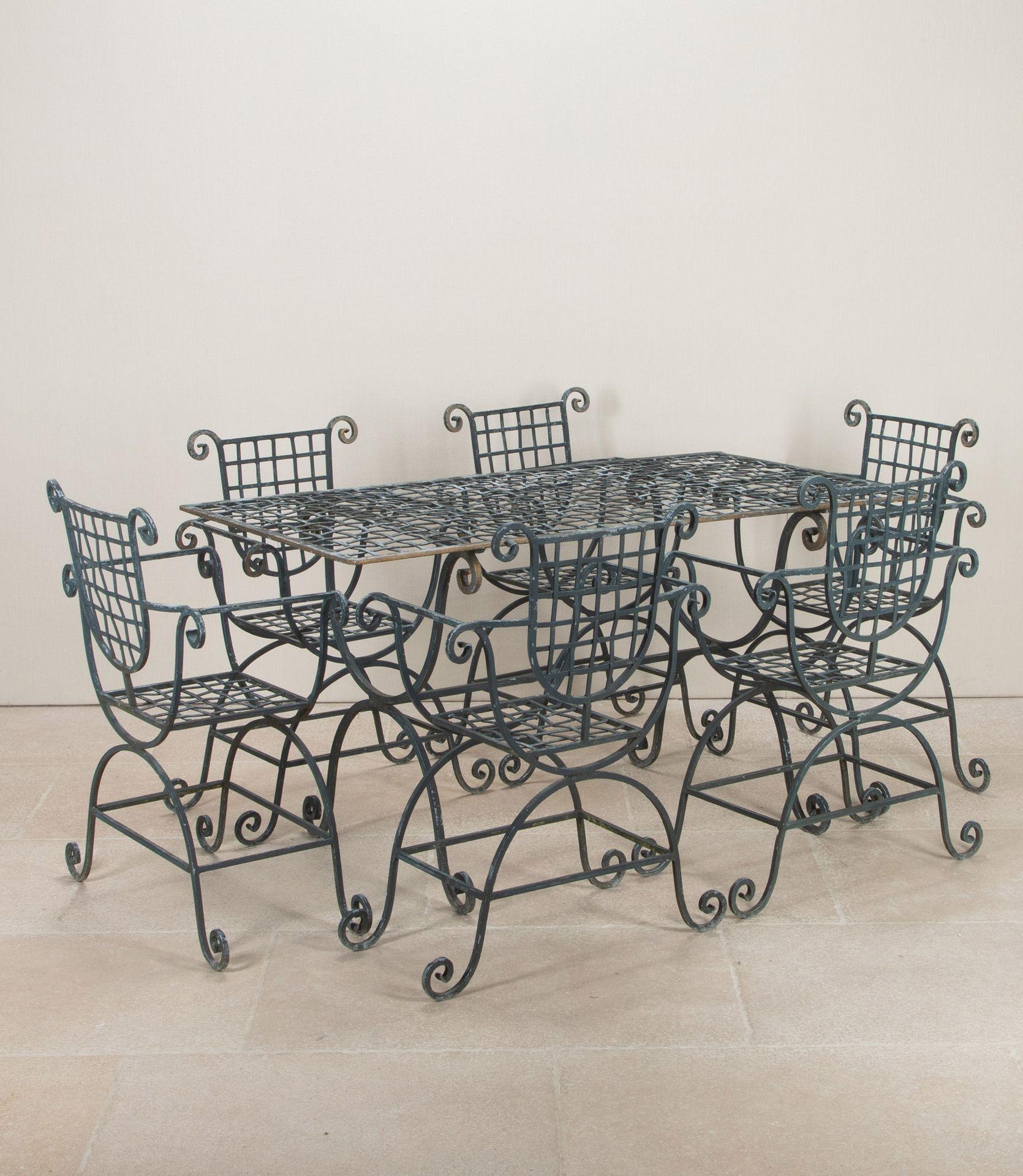 Interesting set of 20th Century compact wrought iron table and six matching chairs. 
Quirky shaped chairs and a rectangular table with crosshatch effect top.