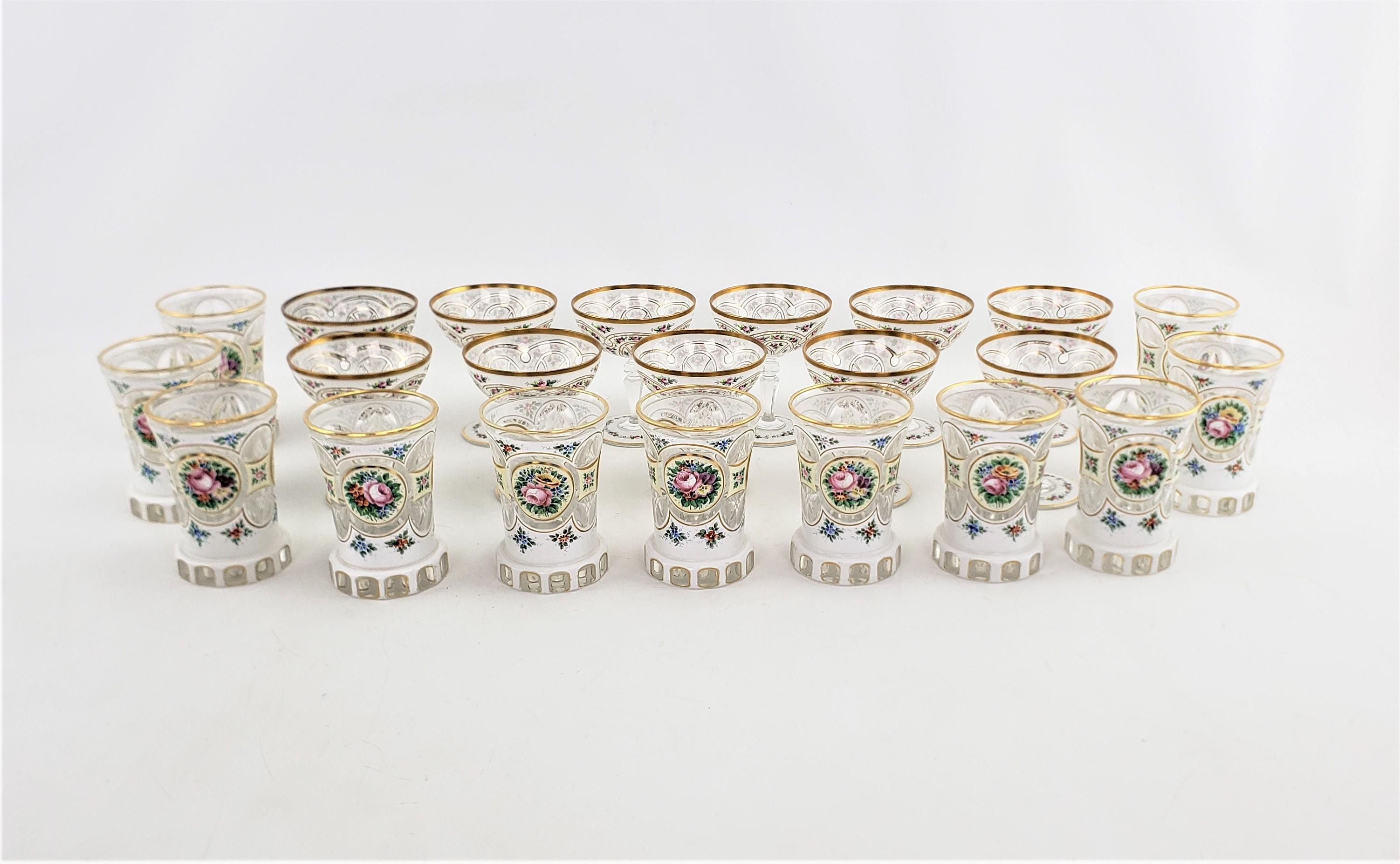 These antique crystal glasses are unsigned, but presumed to have originated from the Czech Republic and dating to possibly 1920 and done in the Art Deco Moser style. The set is composed of eleven champagne glasses and eleven water glasses. The