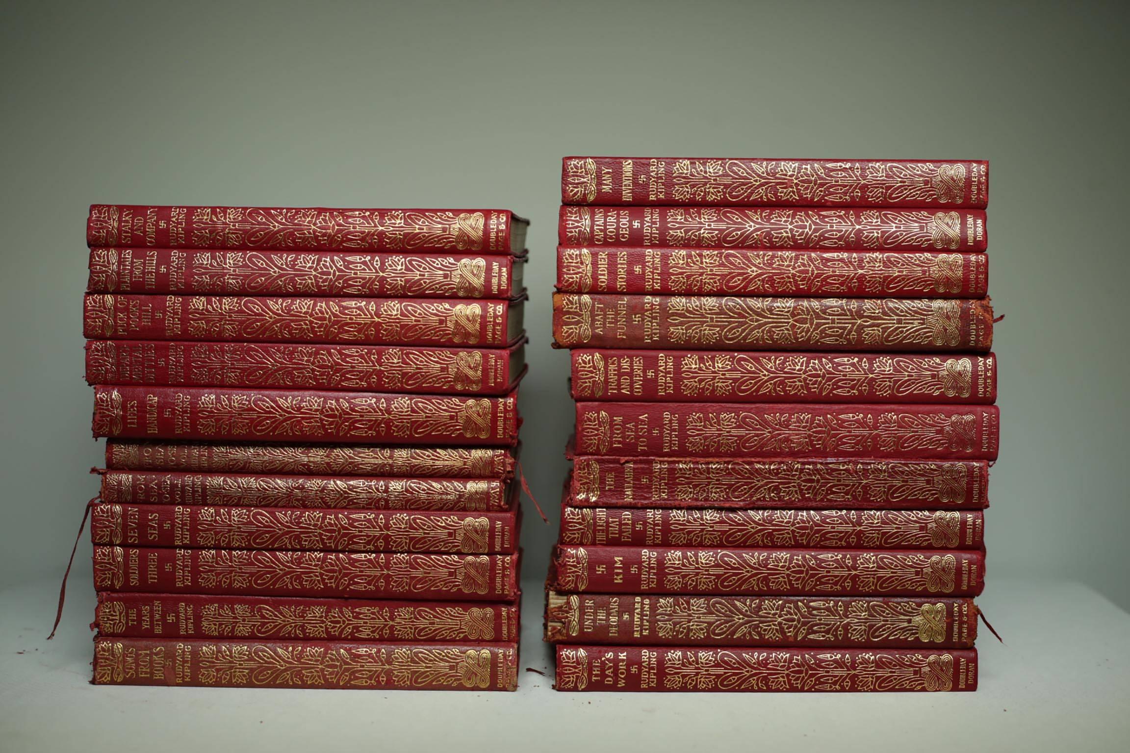 Set of 22 books with beautiful soft red leather, gold accents and gold trim on the top of each book. 
Novels include: 

