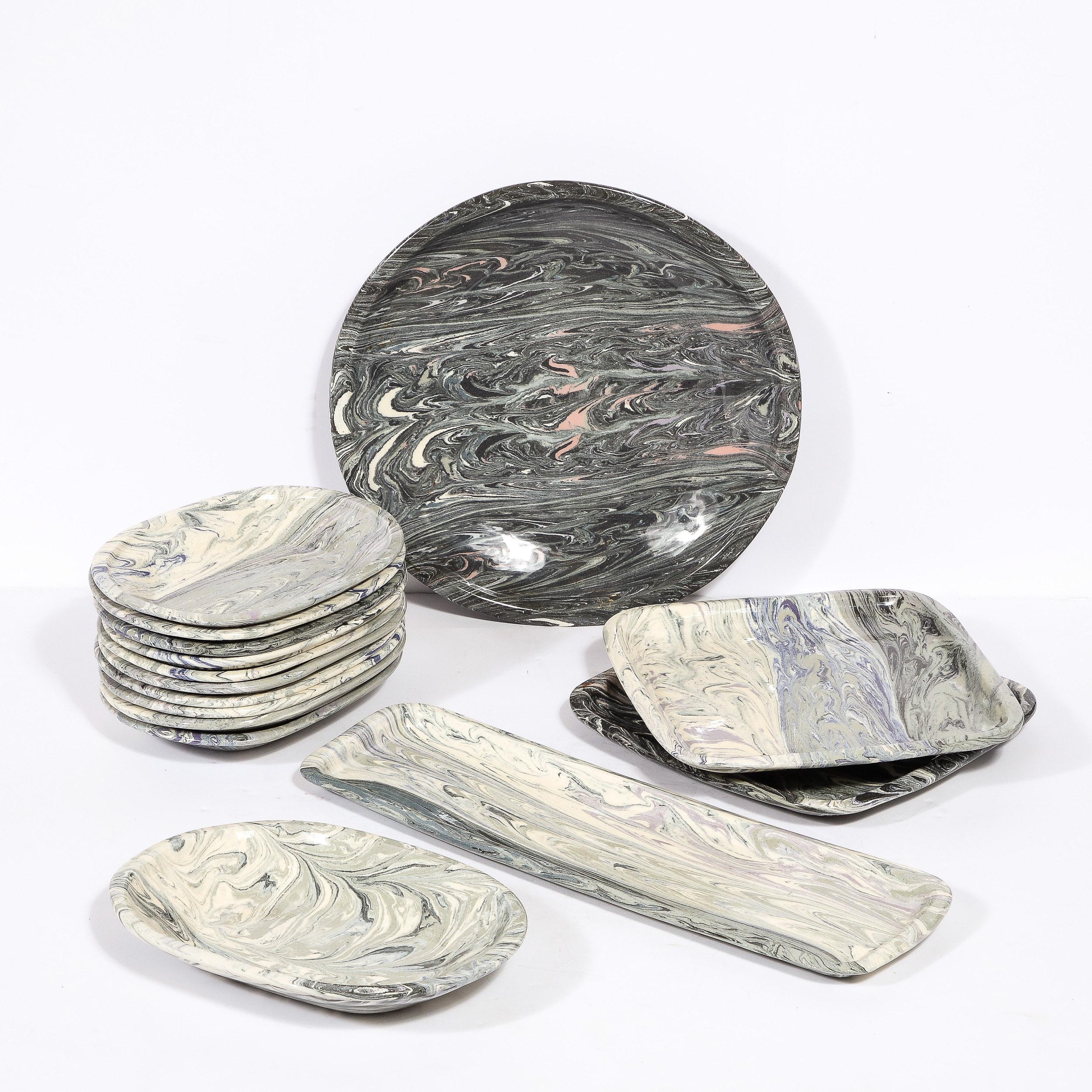 This sophisticated modernist set of 23 dinner and salad plates, as well as serving platters were realized by the esteemed designer Jurg Lanrein in Switzerland during the latter half of the 20th century. They offer an organic marbled texture-