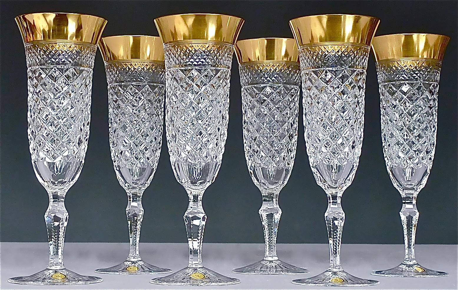 Gorgeous 20th century hand-crafted faceted crystal glass set with 24 carat gold rim made by Josephinenhuette Moser around 1960-70 and very in the style of the exclusive french company Baccarat or Saint Louis thistle. This set of 24 pieces comprises