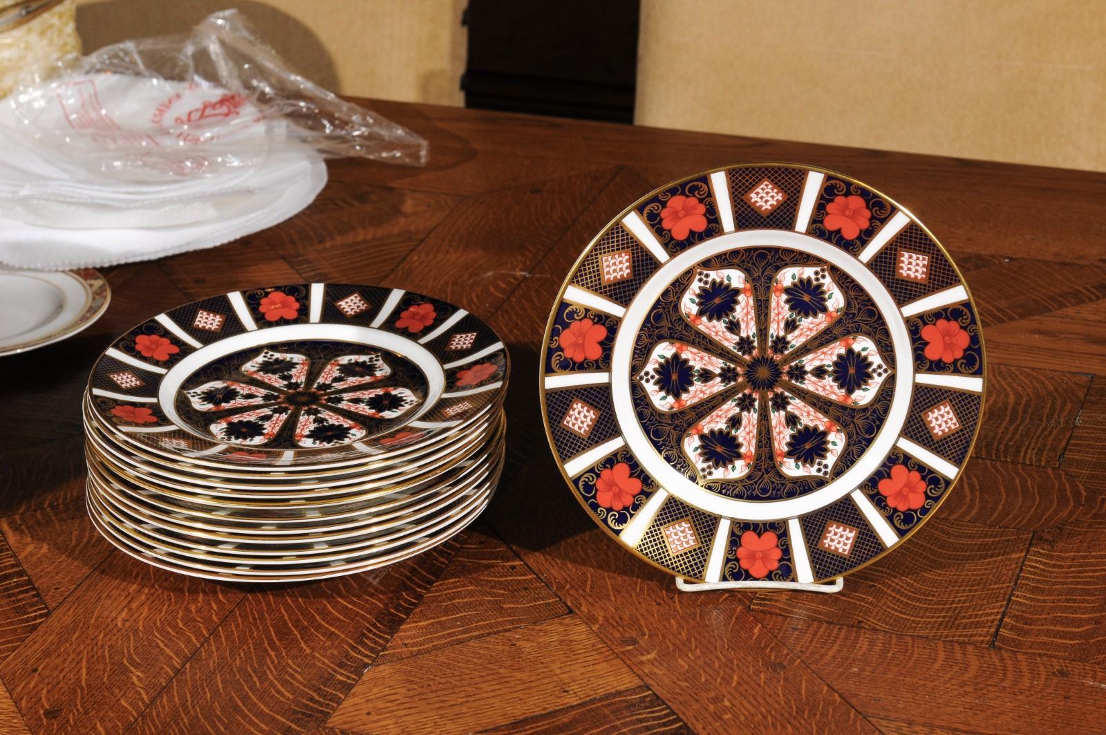 A set of 24 English Royal Crown Derby Porcelain plates with Old Imari 1128 patterns. Born in England in 1995, this set of 24 plates was produced by the Royal Crown Derby Porcelain company, famous for its high quality bone china. Adorned with the