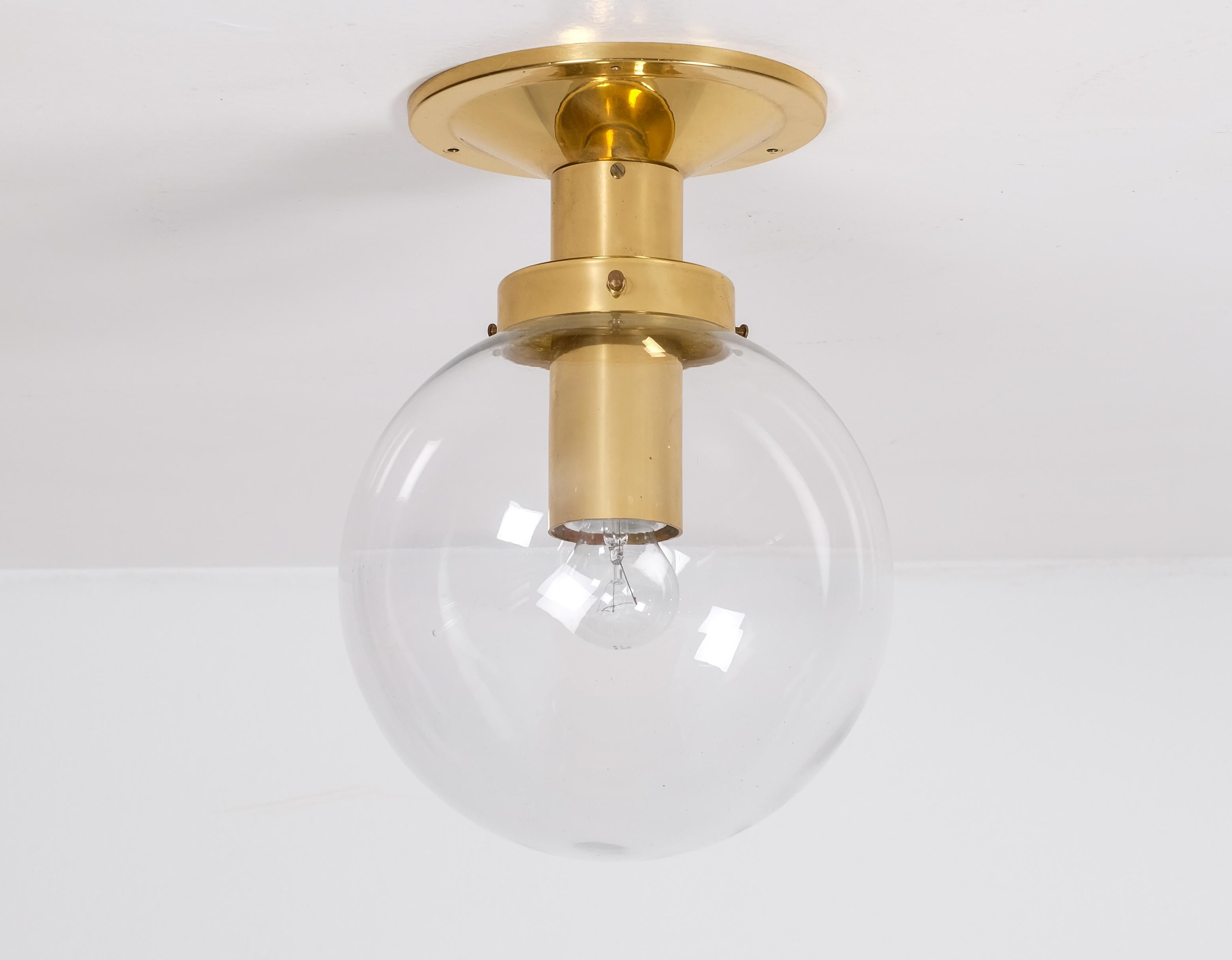 Flush mount glass globe light model T472 in brass by Hans-Agne Jakobsson, 1970s. 
Set of 25 available. Listed price is for a one (1) light. 
Measure: Height: 35 cm.