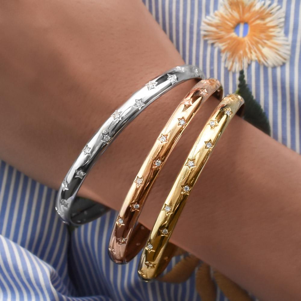 Crafted in Italy by Aldo Garavelli.  Set of 3 bangles set in 18KT Rose, Yellow and White gold. Each bangle has 28 stars, each set with a round brilliant diamond. 
Total diamond weight of each bangle bracelet is 0.68ct.
Total diamond weight of all