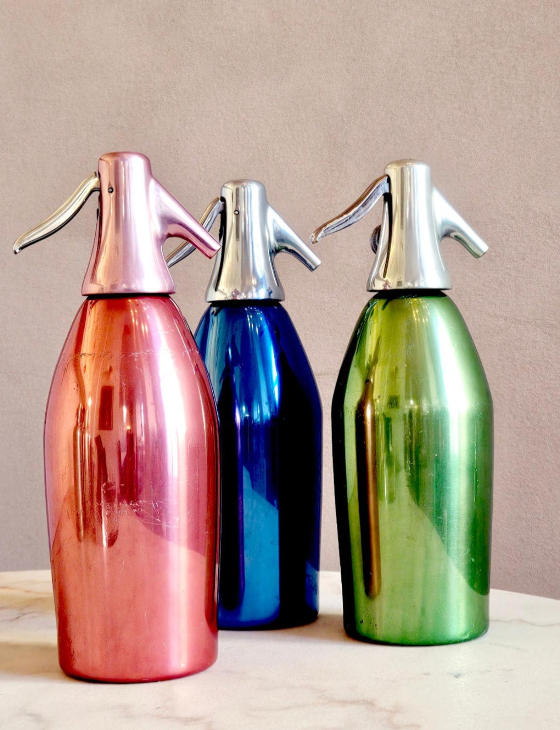 A set of three 1955 S.A.C.A.B Milano Metal Soda Fountains. These fabulously coloured bottles come in Pink, Green and Blue. Perfect as decorative pieces or for a home bar.