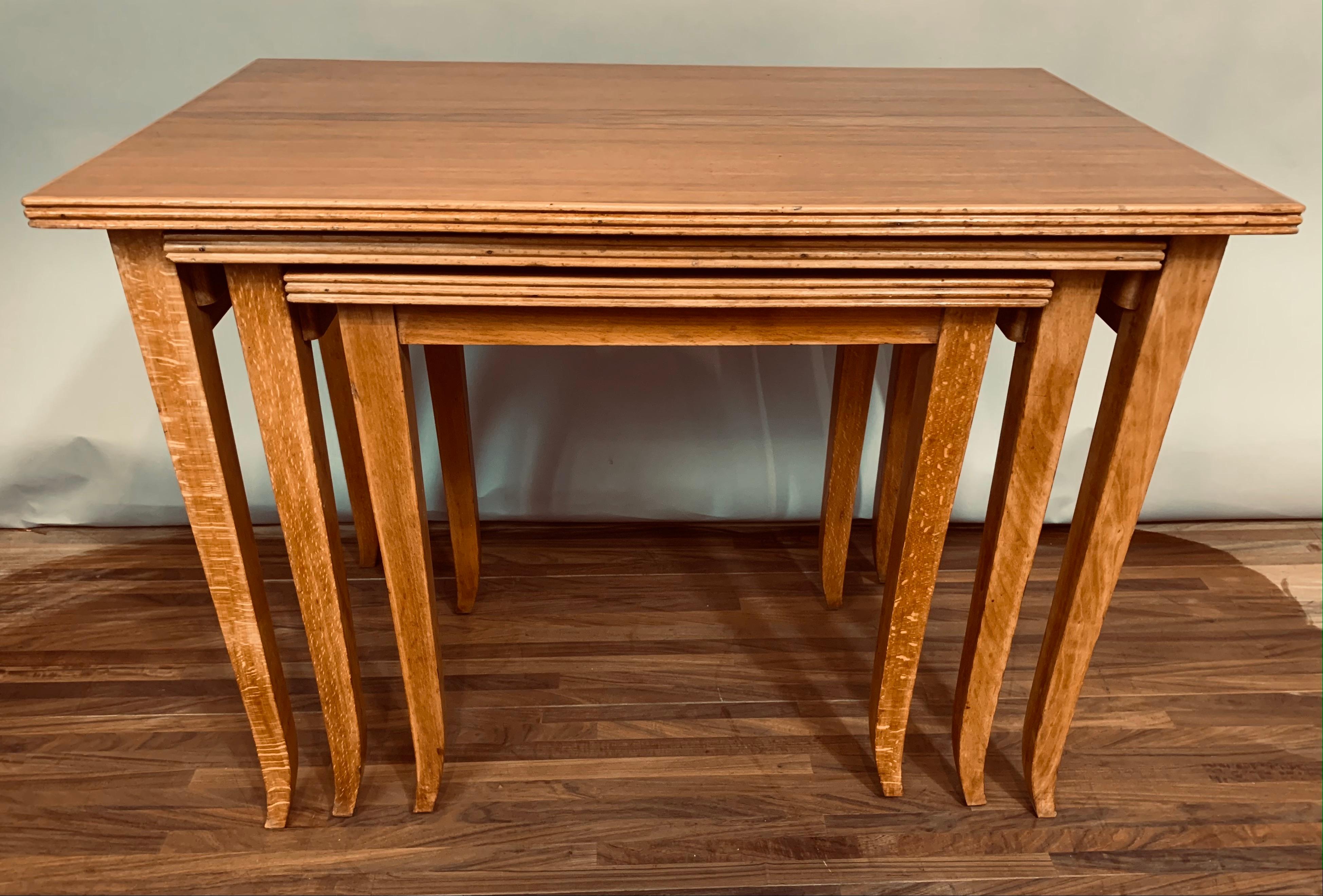 Set of 3, 1960s, nest of teak stackable tables. Made in England. Well-made, sturdy and fully functional. The tables have a wonderful deep and even grain. Designed to slot into one other when not in use and for storage purposes. The edge of each