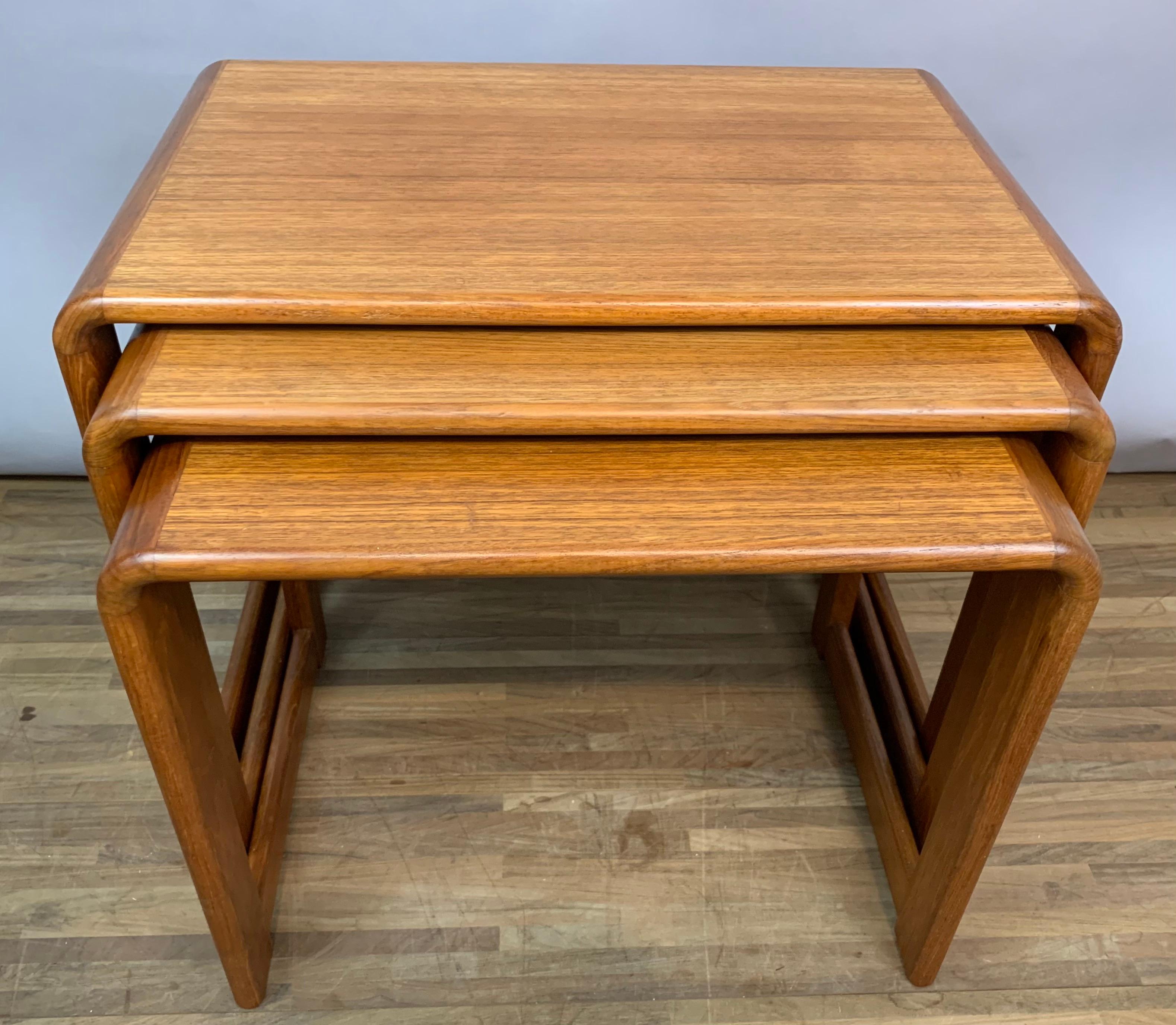 Set of 3, 1960s, nest of teak tables. Made in England. Very well-made, sturdy and fully functional with rounded edges, rectangular sides and lengthways back supports. The tables have been fully restored but there are some areas of slight