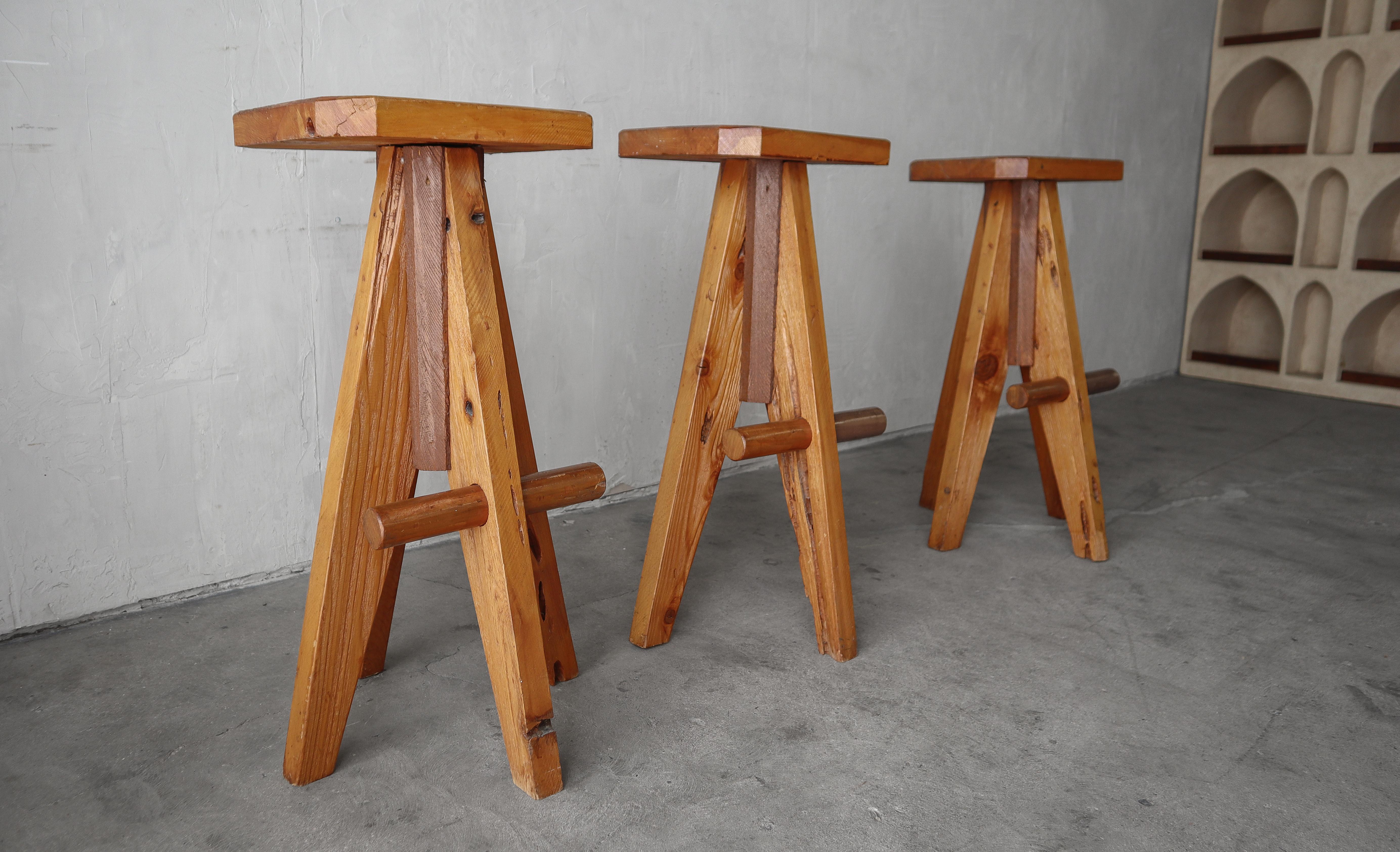 Nice set of 3 Scandinavian modernist stools.  These stools are the perfect example of organic modern.  The warm pine wood angularly crafted gives them an edgy appeal that still feel homey.  They will truly mesh well in most decors.

Stools are solid