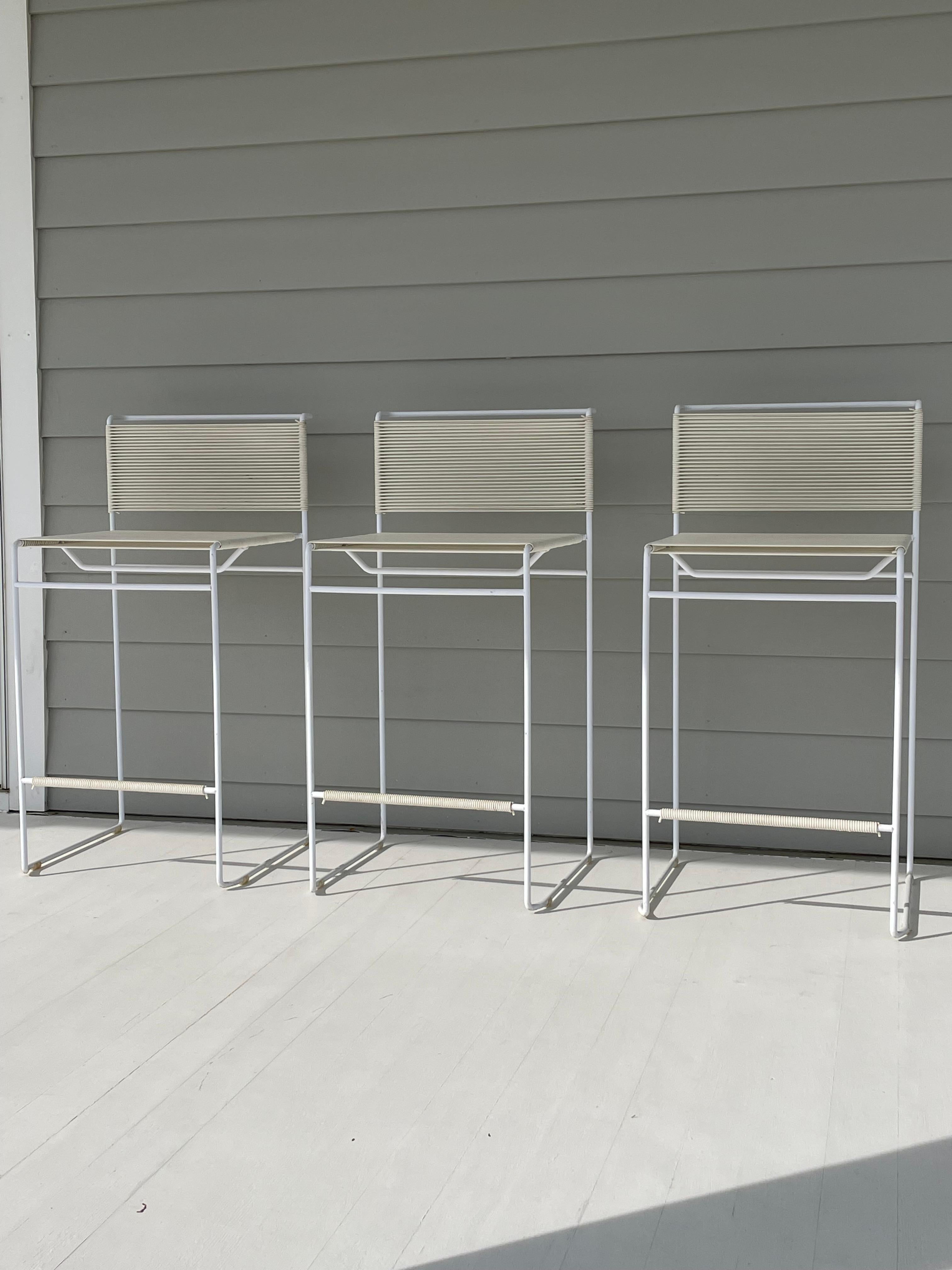 Set of 3 iconic “Spaghetti “ stools designed by Giandomenico Belotti for Fly Line Italy in the 1970s . These are the first edition design and stackable. A minimalistic and sleek design of Italian modernism featuring a painted steel frame with PVC