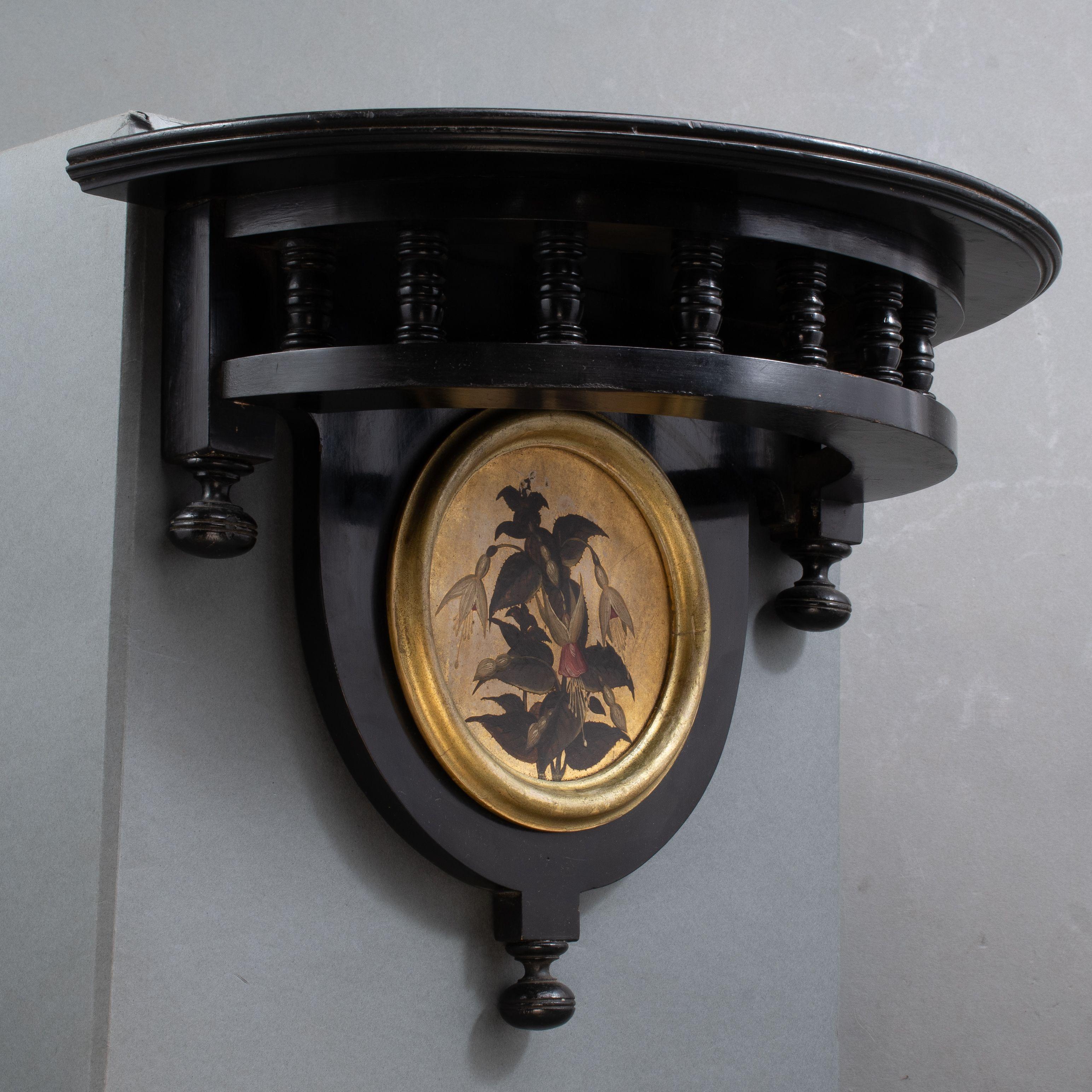 Maple & Co. A set of three little Aesthetic Movement ebonized wall shelves with D shaped shelves, a turned gallery below and turned finials two with hand painted river scenes of a swan, and a heron and one with flowering fuschias.
The last image