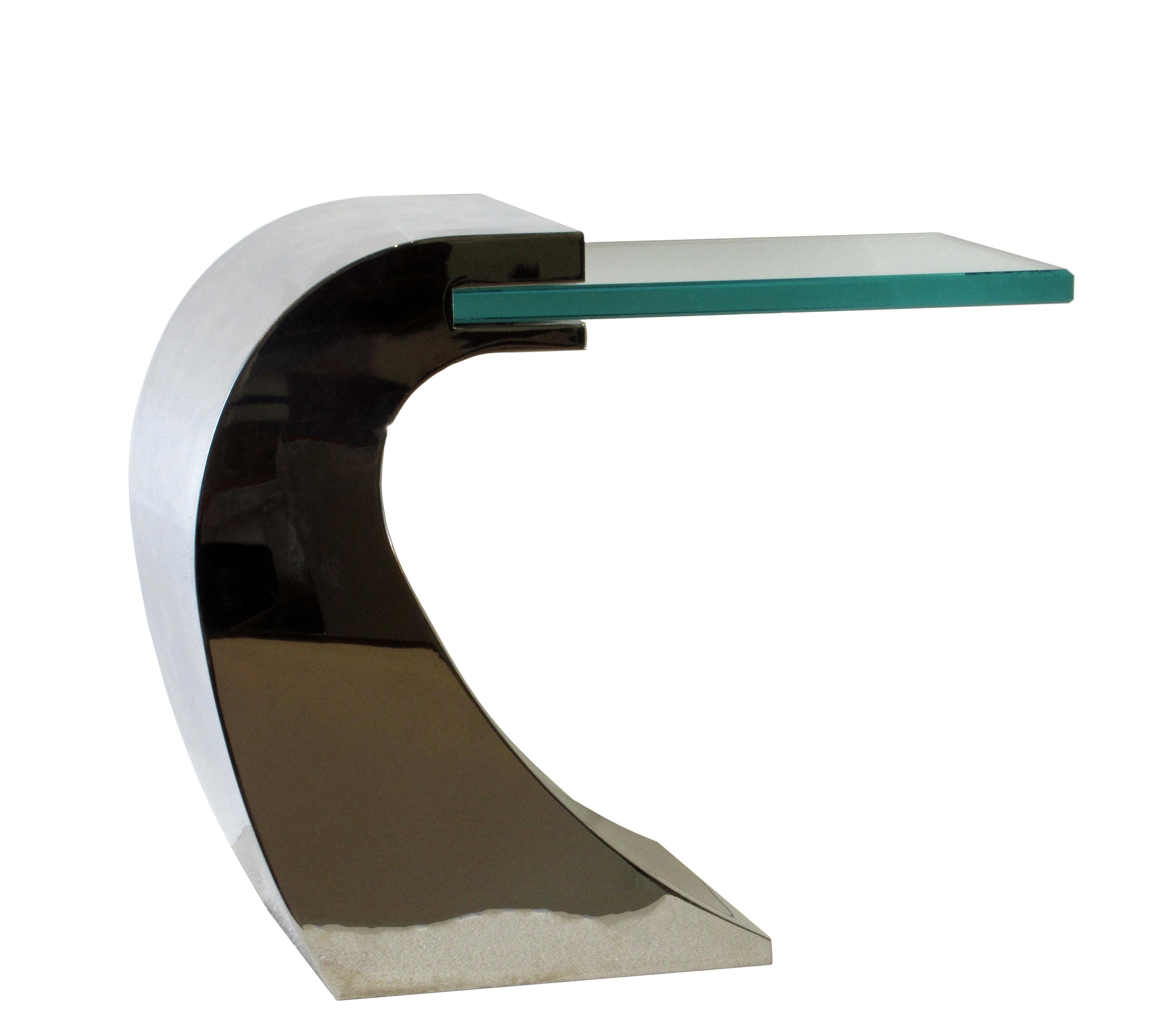 Chrome and glass side table with cantilevered glass inset in a weighted curved polished chrome base.