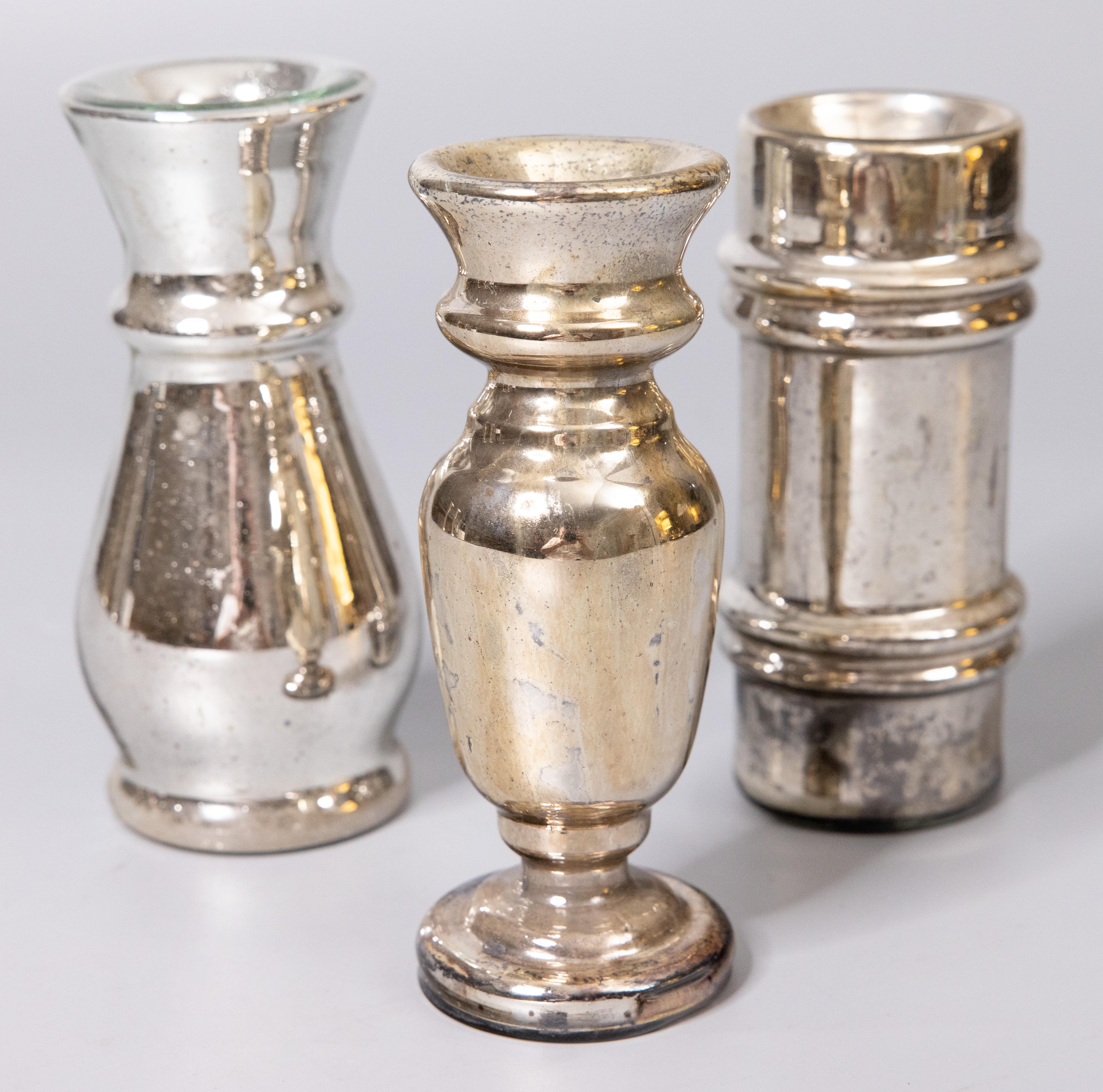 A lovely set of three authentic antique 19th-century hand blown mercury glass decorative vases from England. These stunning vases have stylish shapes in a beautiful patina and would be the perfect room accent pieces.

Dimensions:
2.5