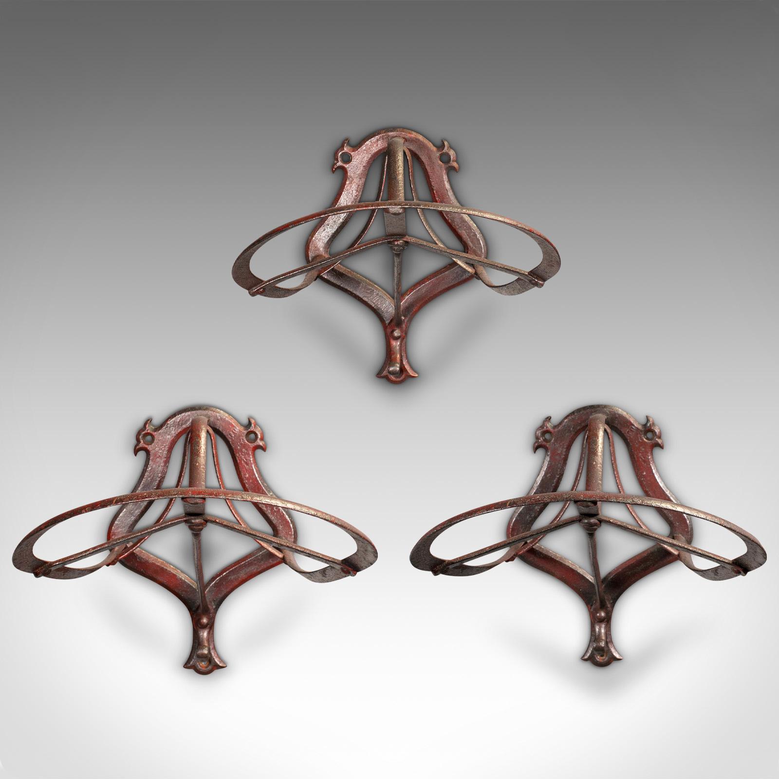 This is a set of 3 Classic 'Duck bill' antique saddle racks. An English, wrought iron wall mounted equestrian tack rest, dating to the late Victorian period, circa 1900.

An attractive trio of saddle racks, ideal for equestrian or display