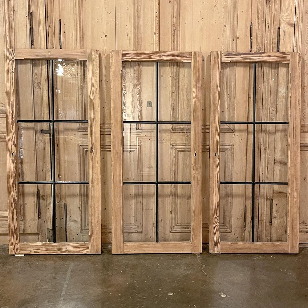 Set of 3 Antique solid pine windows with hand-rolled glass are perfect for finishing out your decorating plans, inside or out! Stripped and ready to stain or paint, or just leave natural, they can make an exquisite room divider, a wall hanging, or