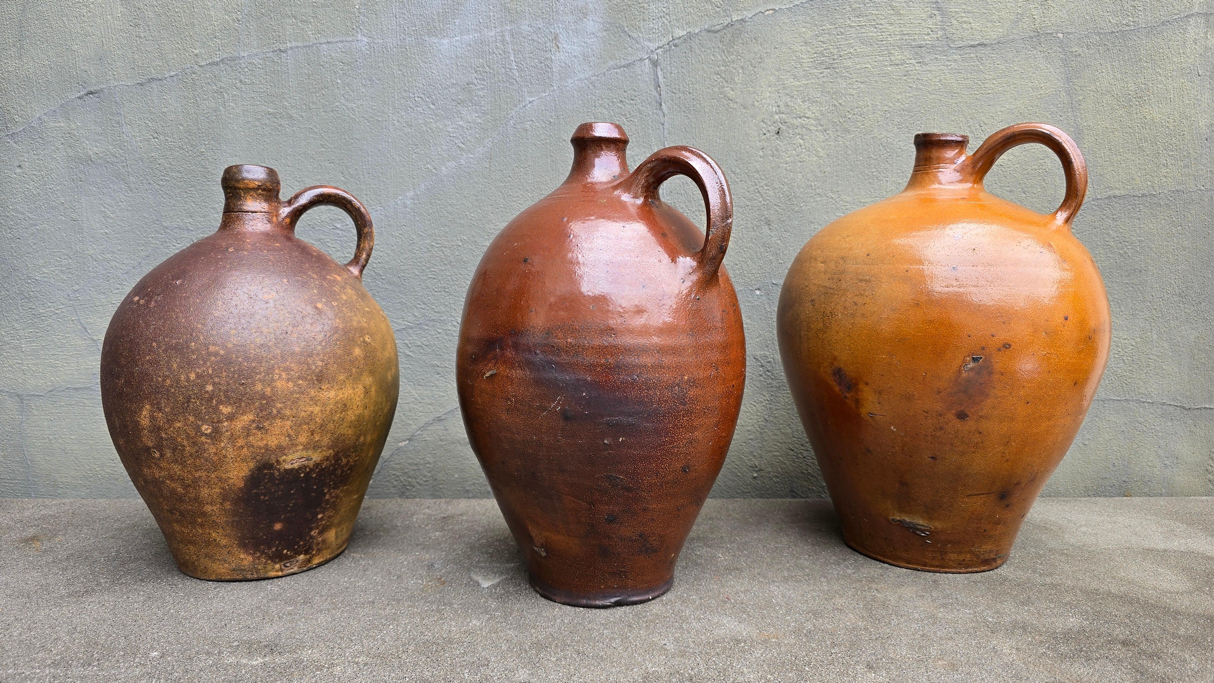 Set of 3 Antique South German Stoneware Jugs – 19th Century, Handcrafted

A striking trio of 19th-century handmade stoneware jugs from Southern Germany, each with its own distinct character, glaze tone, and form. Likely originating from Bavarian or