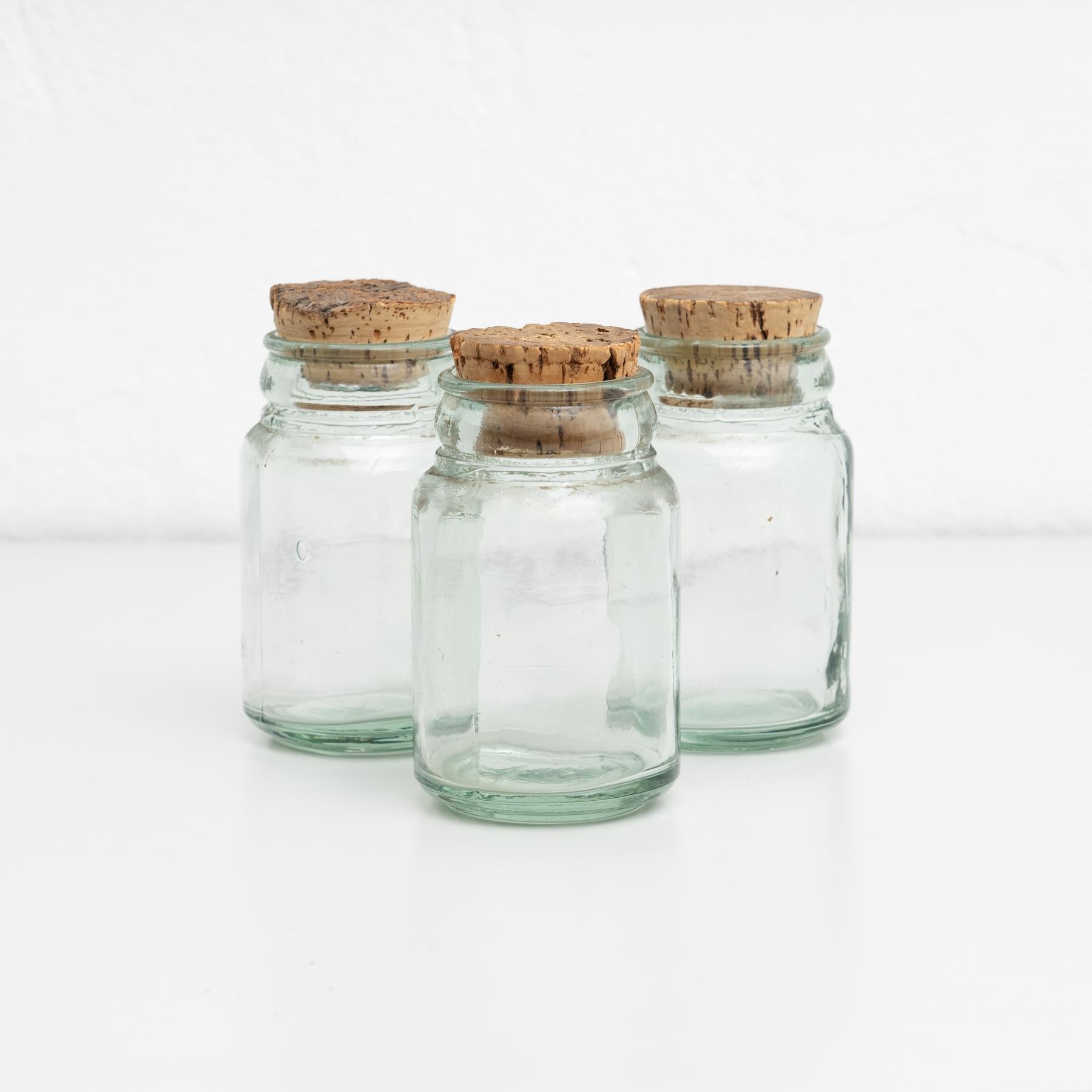 Set of three antique Spanish glass containers dedicated to preserve food. All of them presenting a cork cap.

Made by unknown manufacturer in Spain, circa 1950.

In original condition, with minor wear consistent with age and use, preserving a