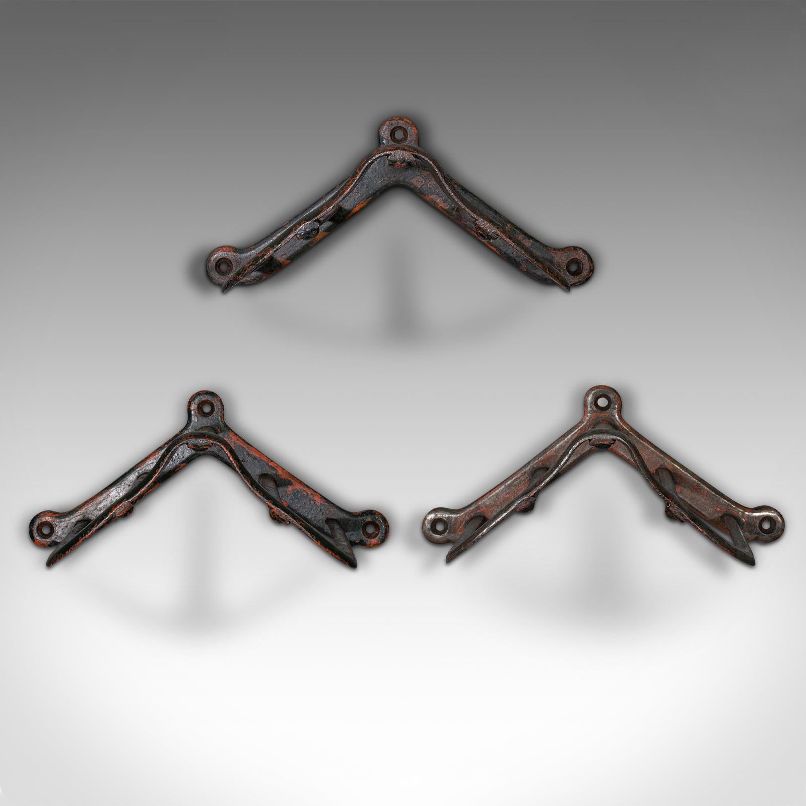 This is a set of 3 antique tack hanging racks. An English, wrought iron equestrian wall mount, dating to the late Victorian period, circa 1900.

Delightfully patinated antique racks, ideal for decorative tea towels or coats as well as equestrian