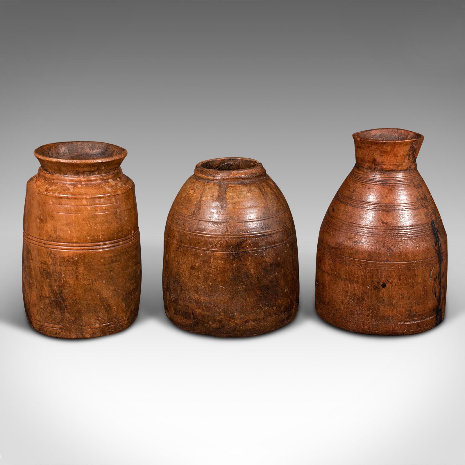 This is a set of 3 antique tribal vases. An Indian, hardwood rustic jar or urn, dating to the late Victorian period, circa 1900.

Each offers naive craftsmanship and a charming appearance
Displaying a desirable aged patina throughout
Hand-carved