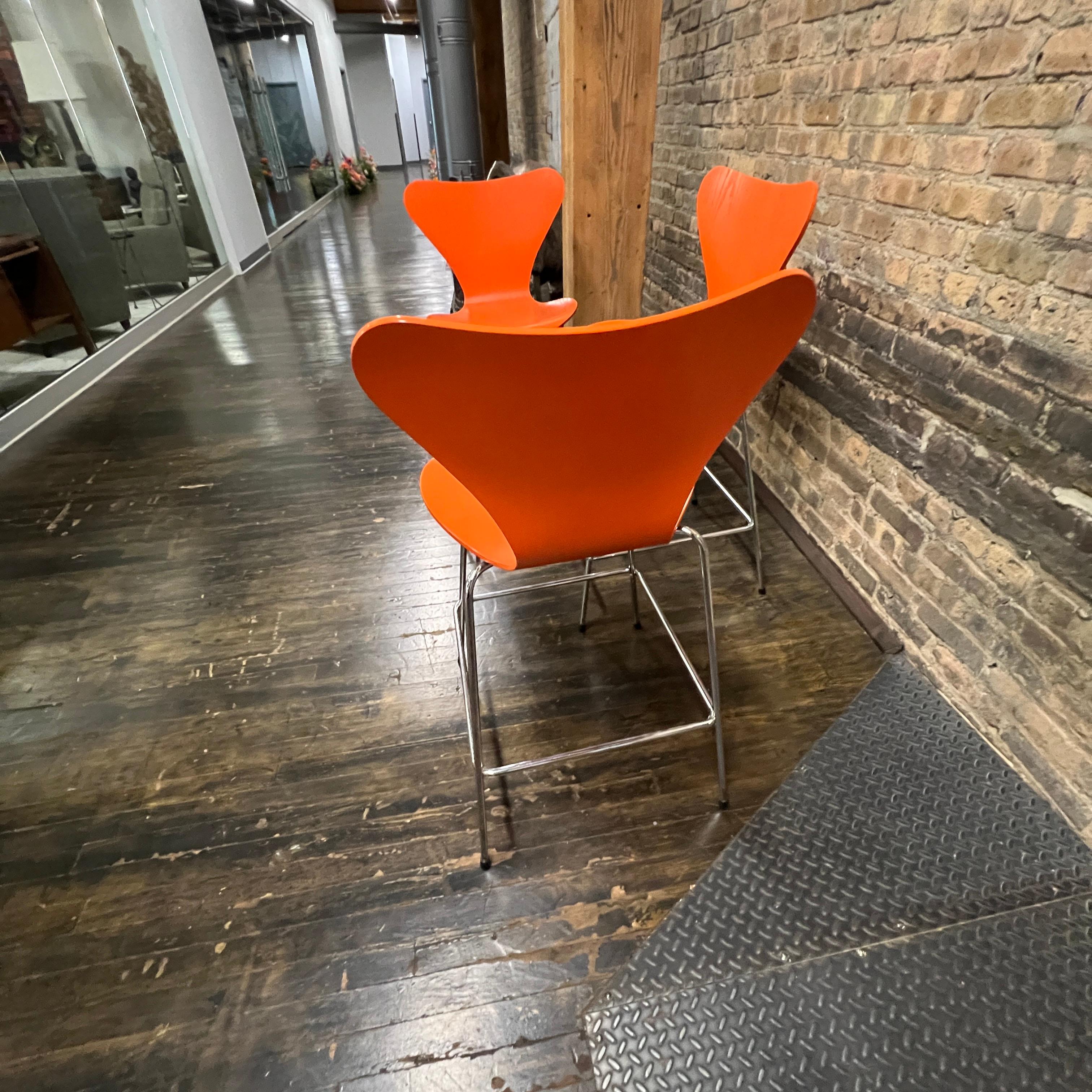 Set of 3 Arne Jacobsen for Fritz Hansen Series 7 Counter Stools in Orange In Good Condition In Chicago, IL