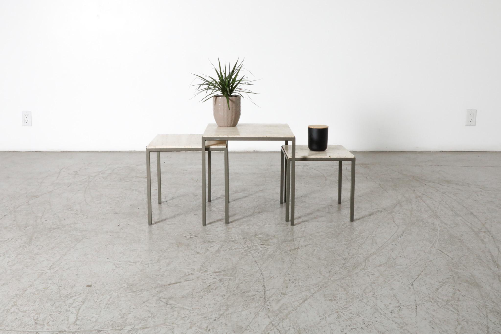 Set of 3 Mid-Century Artimeta attributed nesting tables. Artimeta was founded by Floris H.  Fiedeldij in 1960 and produced luxury lighting and furniture. Gray metal bases paired with beautiful inset travertine tops. In original condition with some