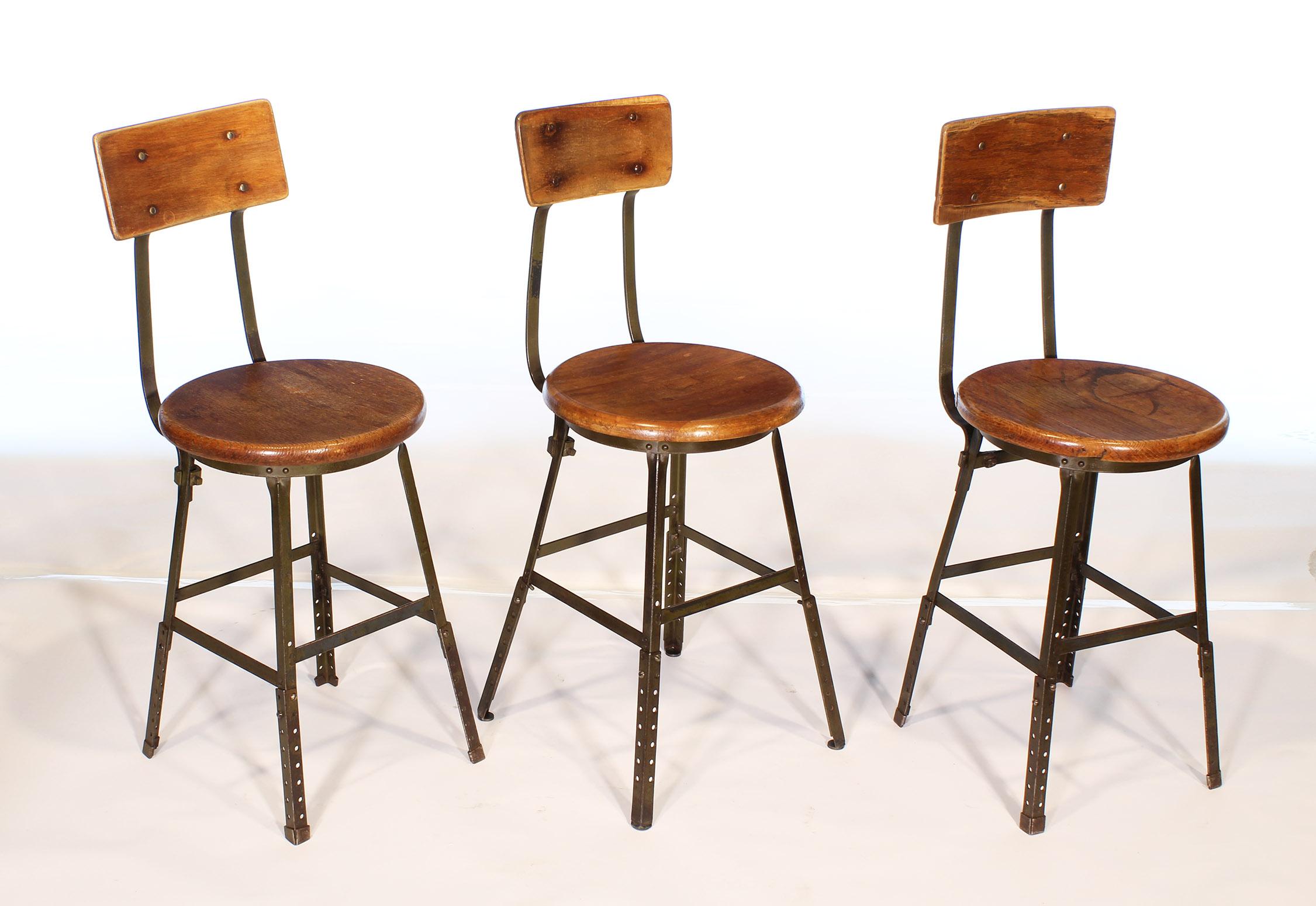 Three authentic vintage factory industrial stools. Made from wood and steel. Distressed army green original paint. Seat diameter 15