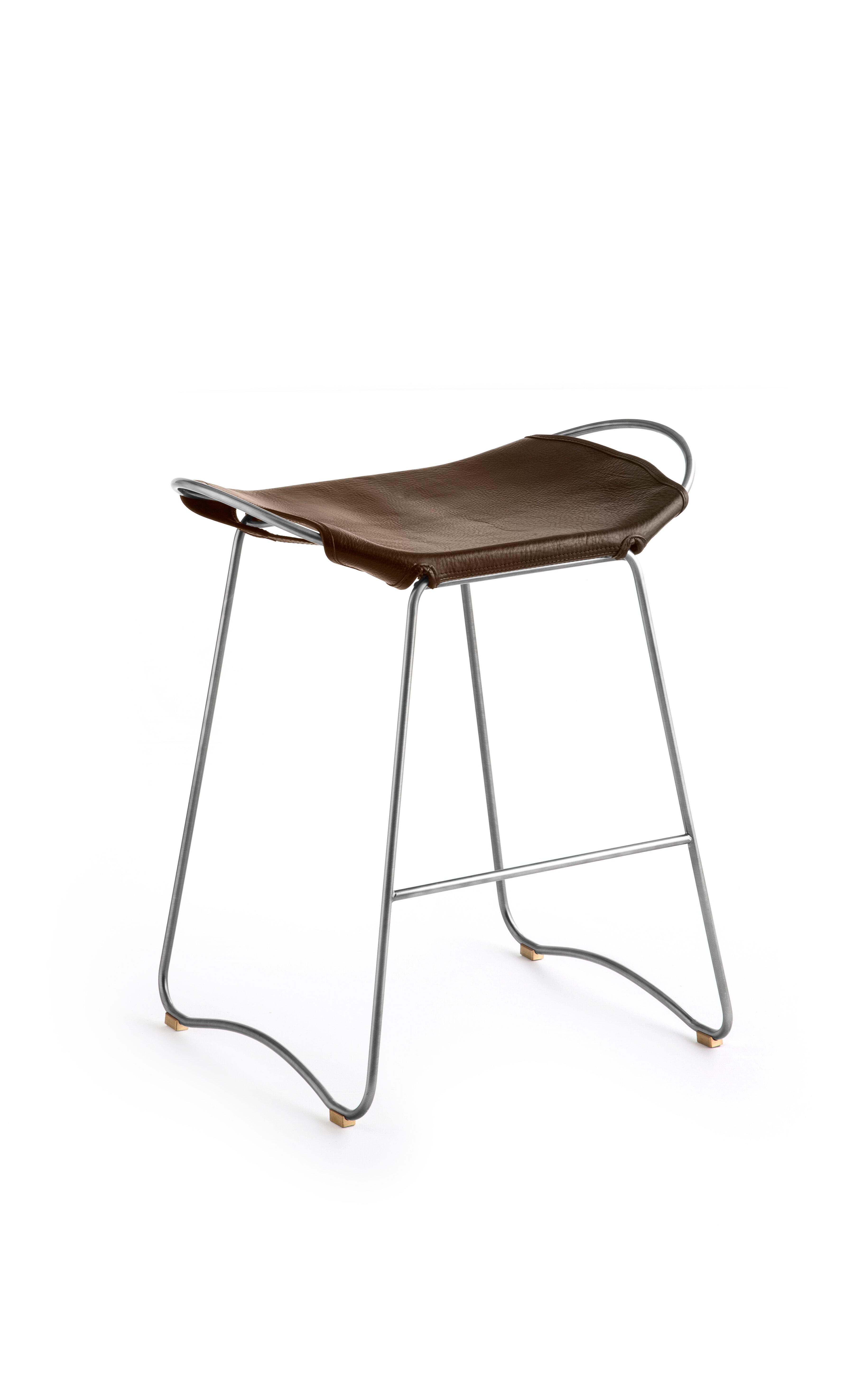The Hug contemporary counter stool is designed and conceived with a light aesthetic, the slight oscillation of the steel rod of 12 mm is complemented by the flexibility of the double 3.5 mm thick leather. When sitting in this furniture you feel an