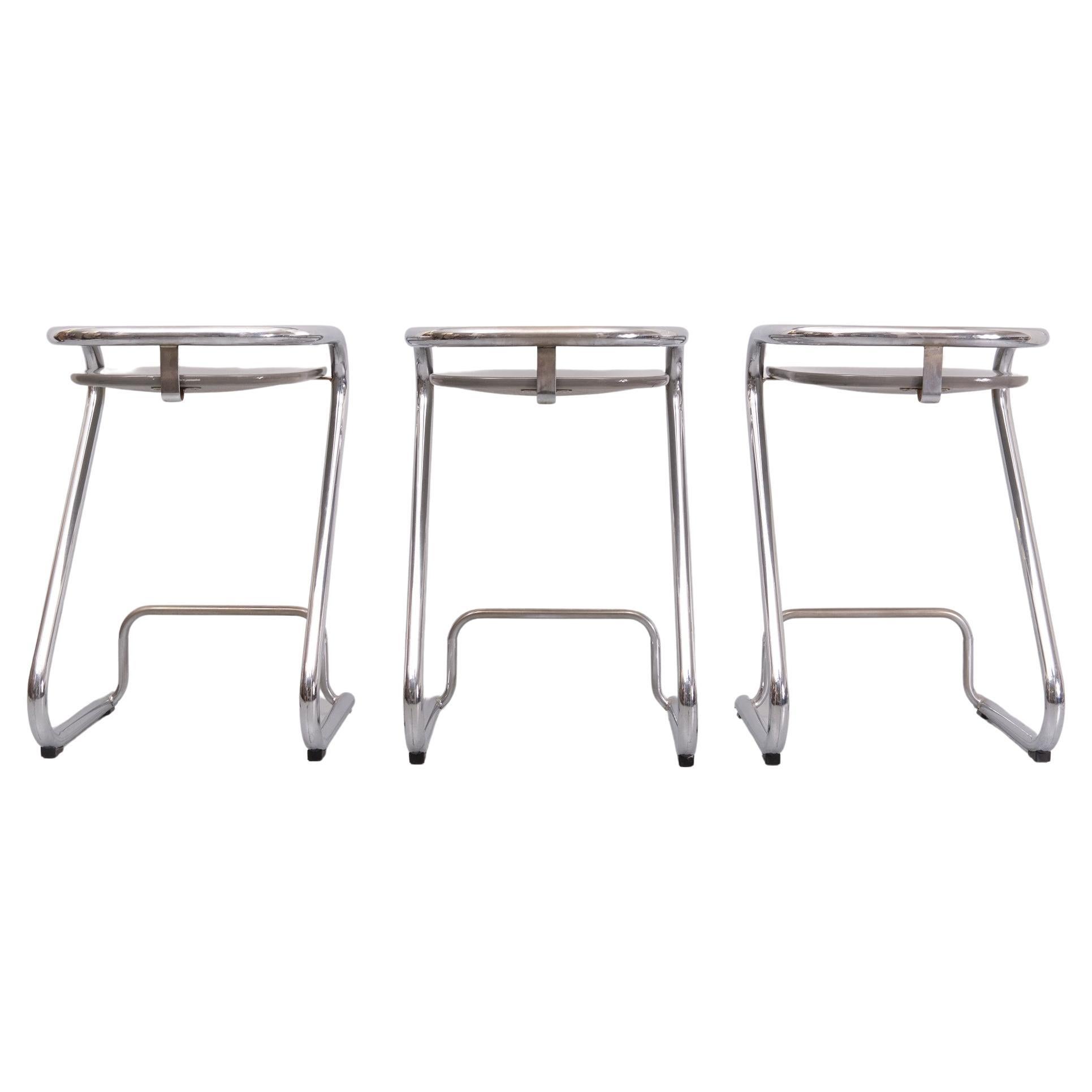 The set of 3 bar stools S 70-3, designed by Lindau and Lindekrantz in 1968 for Lammhults, is in very good condition. The curved chrome is perfect, as are the Grey colored Wooden seat shells. Early 1960s version Lammhults is a Swedish manufacturer