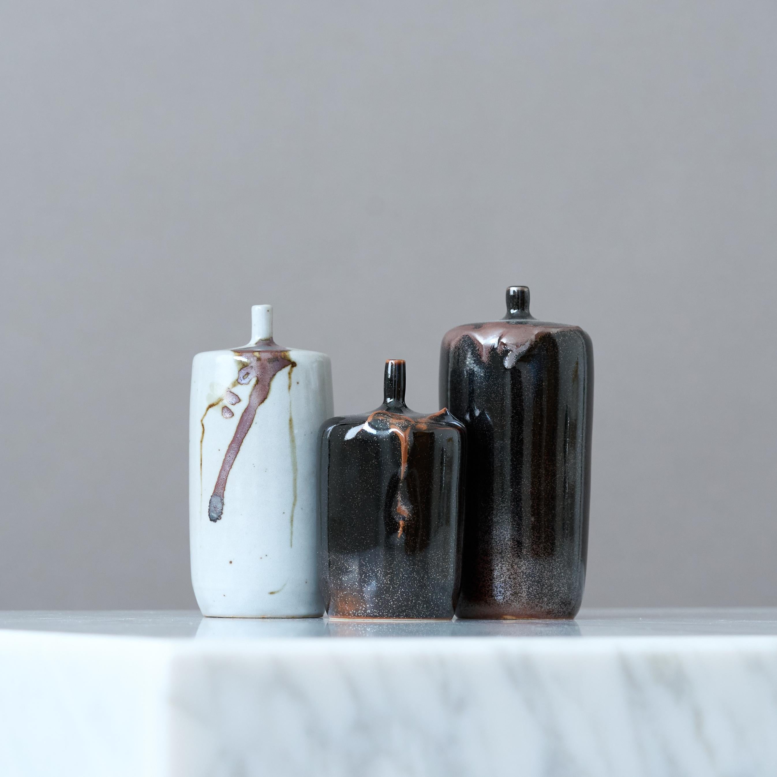 A set of three beautiful stoneware vases with amazing glaze. 
Made by Claes Thell, in the Artist's studio, Höganäs, Sweden, 1986.

Excellent condition. Signed 'Thell '86'.

Claes Thell is a Swedish ceramicist known for his intricate and sculptural