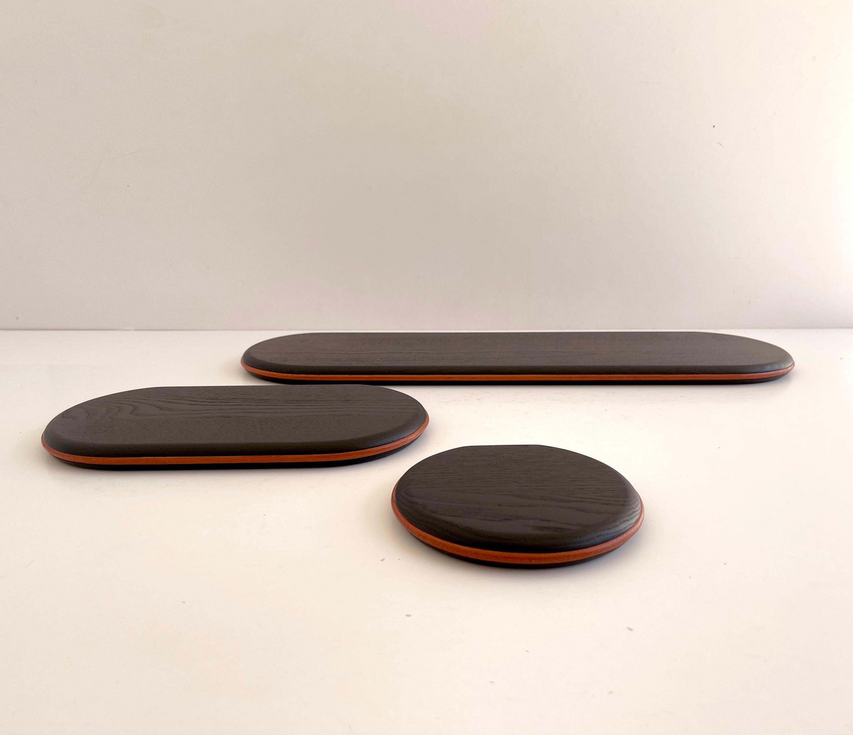 Set of 3 Black Ash and Orange Leather Waly Shelves by Mademoiselle Jo
Dimensions: Round: D 14 x W 15 x H 2 cm.
Small: D 17 x W 30 x H 2 cm.
Large: D 17 x W 60 x H 2 cm.
Materials: Black stained ash and orange leather.

Available in two wood colors.