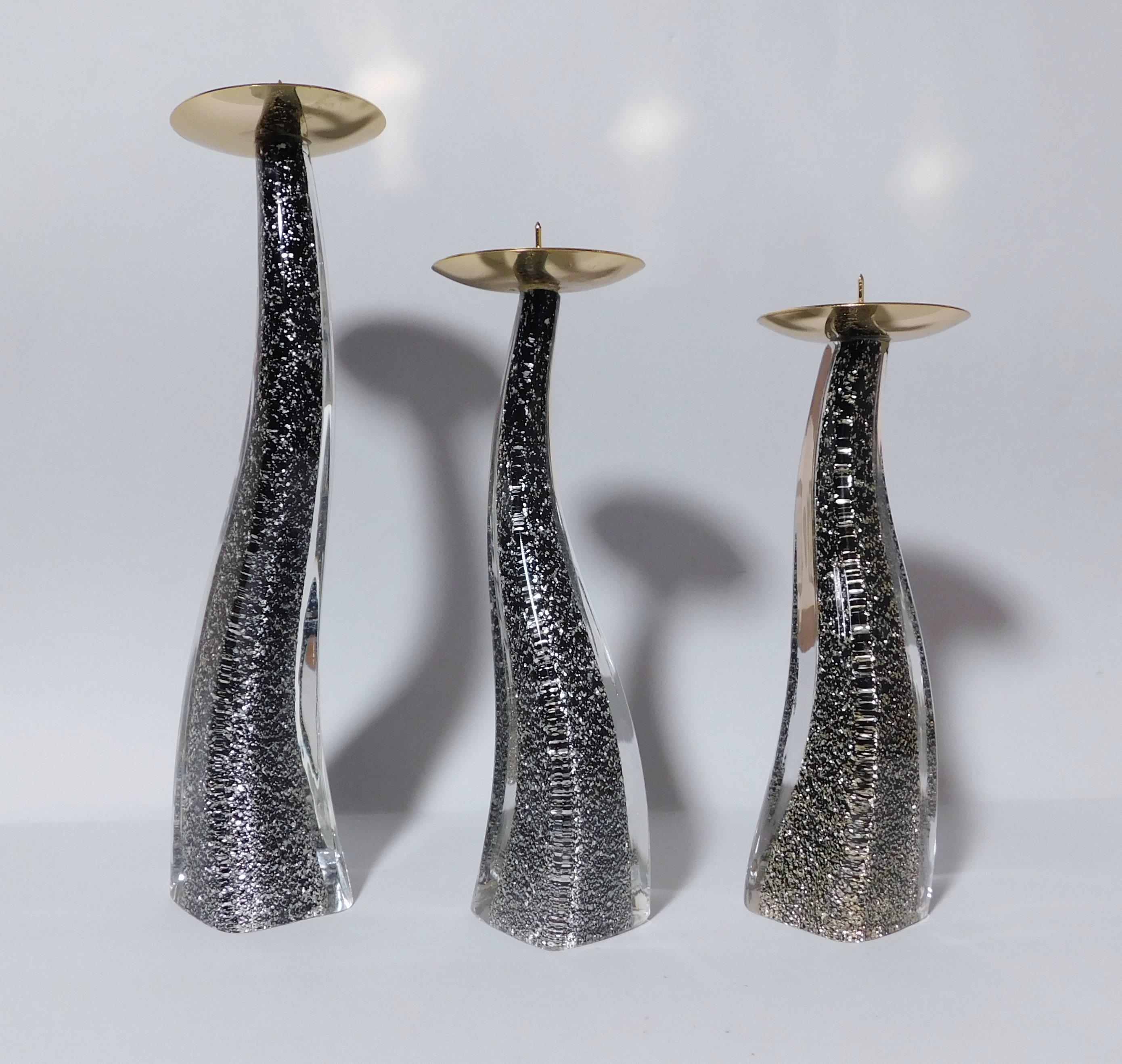 Italian curved Murano candlestick hand blown in black and clear glass infused with silver specks, made in Italy by Maurizio Toso, circa 1980s 
Original maker's mark on the base
Measures: height 10.5 inches, 8.5 inches and 8 inches, diameter 2