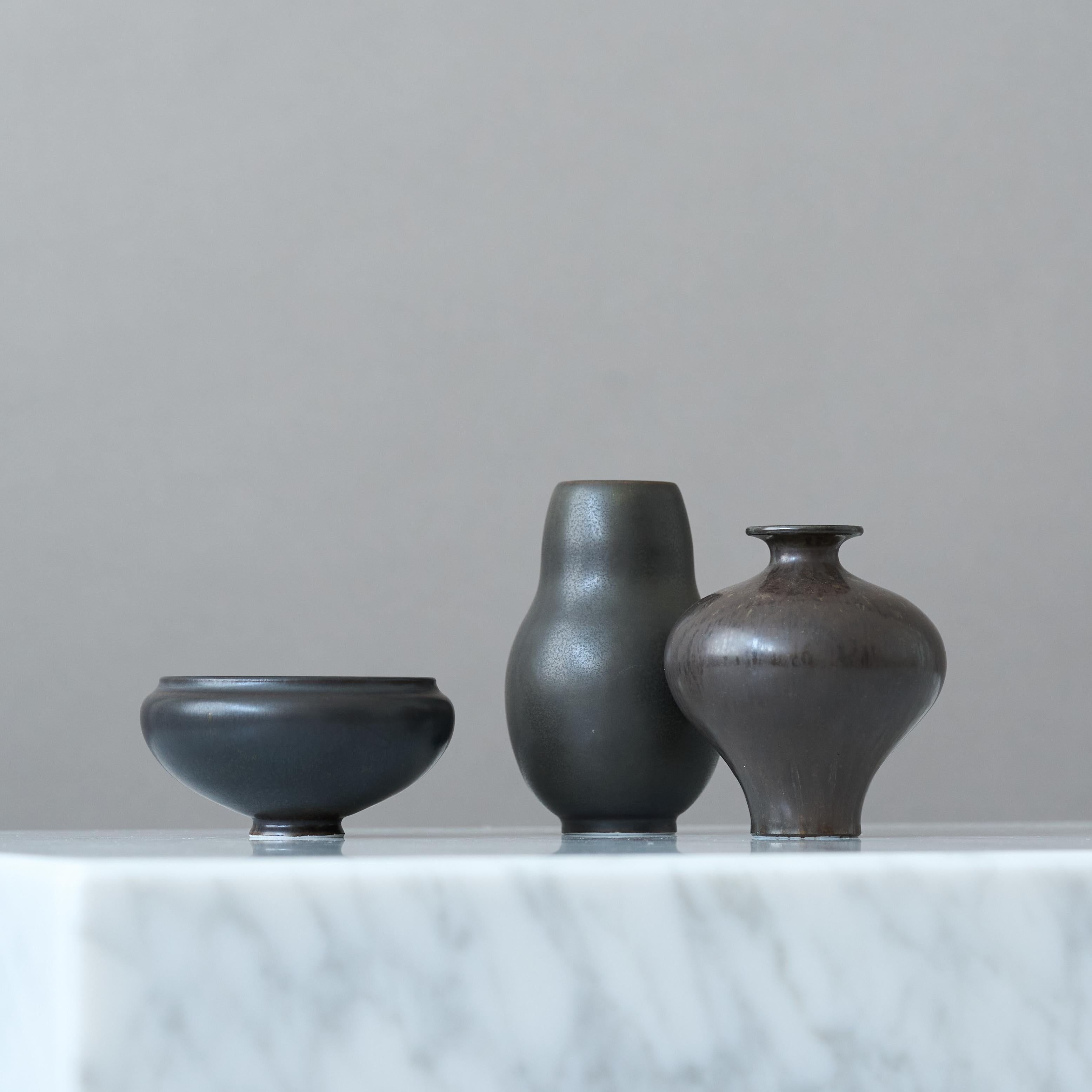 A set of three beautiful black and brown stoneware miniatures with amazing glaze. 
Made by Gunnar Nylund for Rorstrand, Sweden, 1950s.

Great condition. 
Signed with 'GN' and makers mark.

Gunnar Nylund (1904-1997) was born in Paris, France. His
