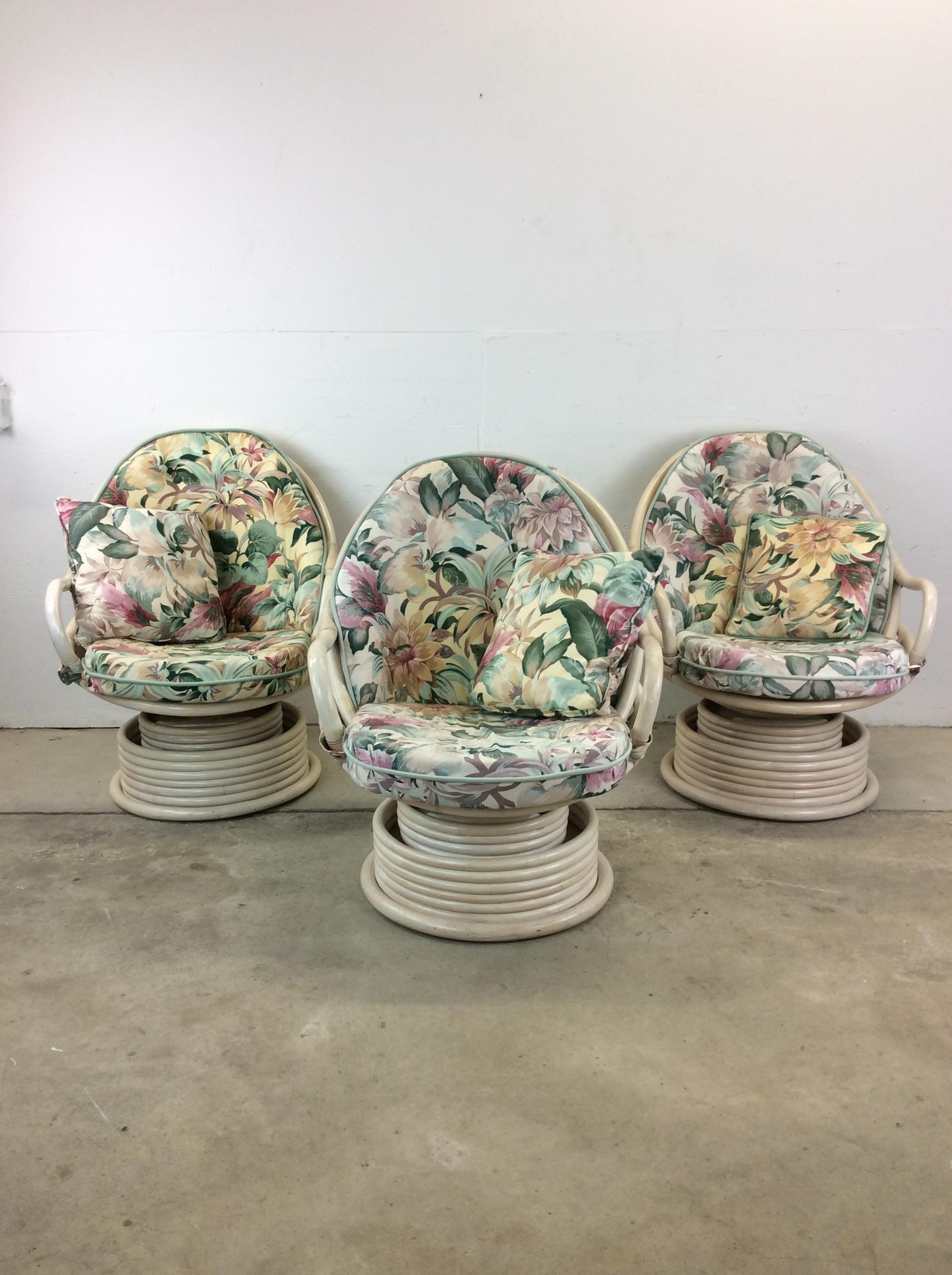 This set of 3 lounge chairs features solid rattan construction, original white washed finish, vintage floral upholstery, and swivel base.

Dimensions: 29w 24d 37h 19sh 23.5ah

Condition: Original. white washed finish is in good condition. Only minor