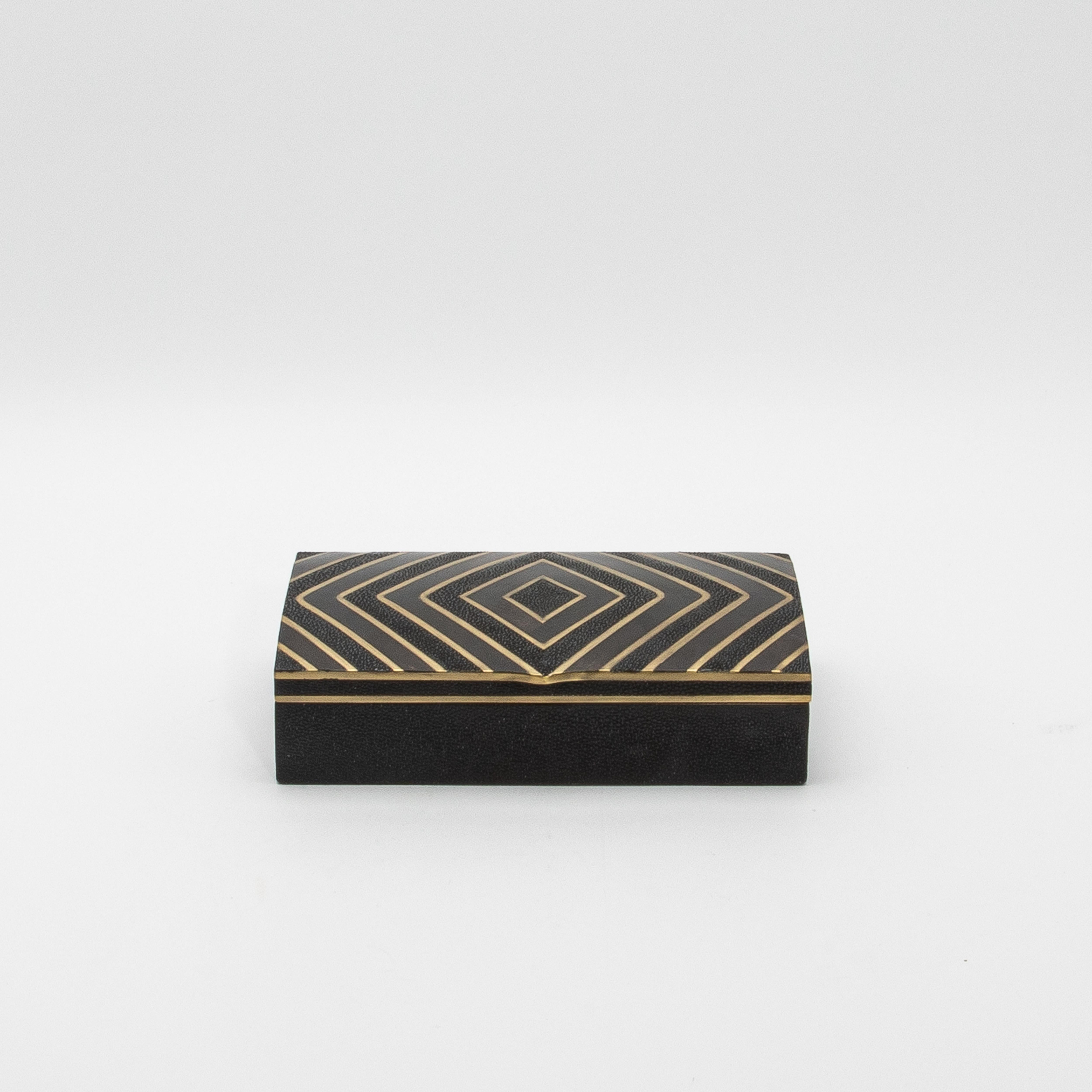 The set of 3 boxes by R&Y Augousti in black oak with black shell and brass details embodies timeless sophistication with a modern edge. Each box features a mesmerizing zig-zag pattern in a harmonious blend of bronze patina brass, black shell, and