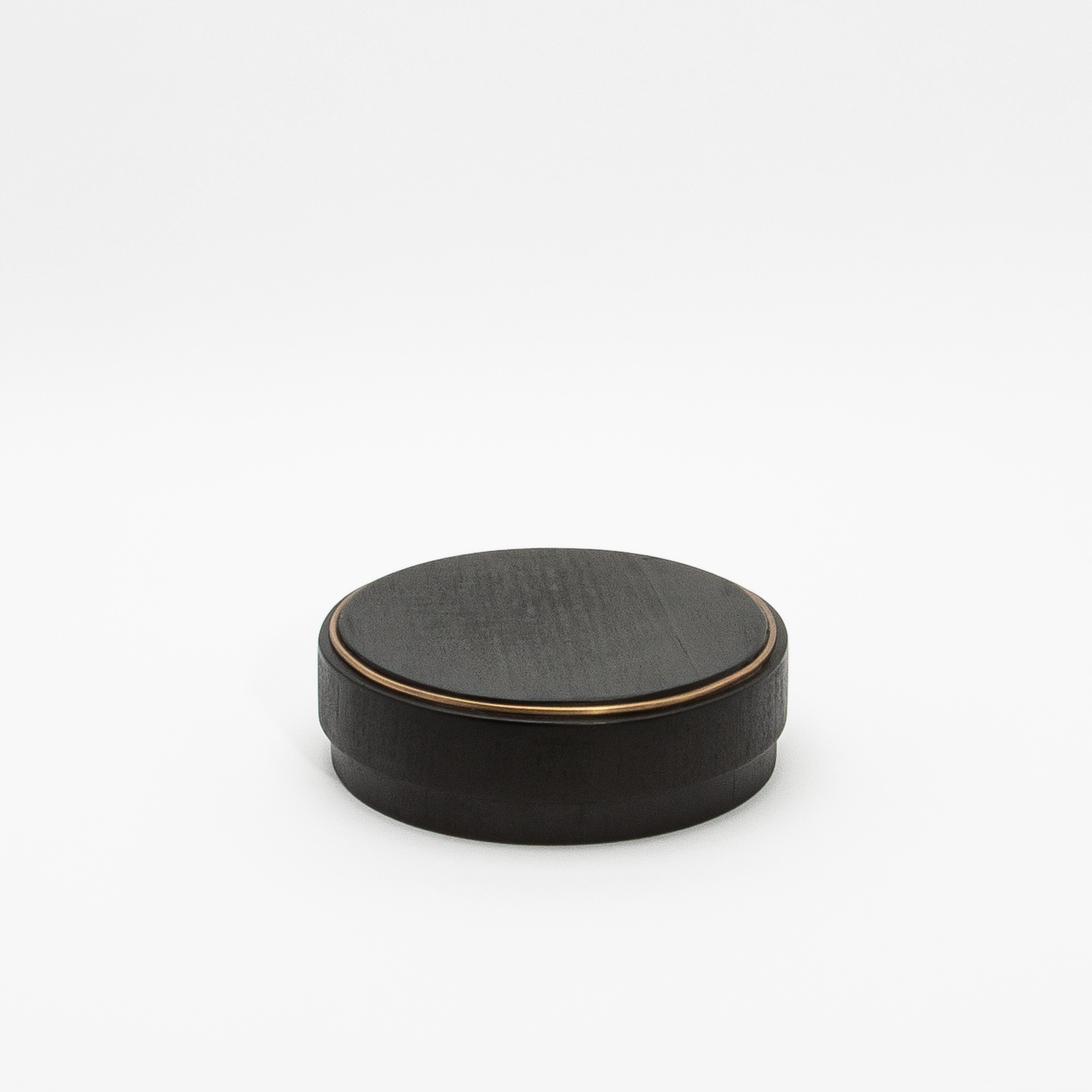 This set of 3 round boxes in black shagreen by R&Y Augousti showcases a design that seamlessly marries form and function. Each box features a perfectly symmetrical circular shape, exuding a modern elegance that draws the eye. The contrast between