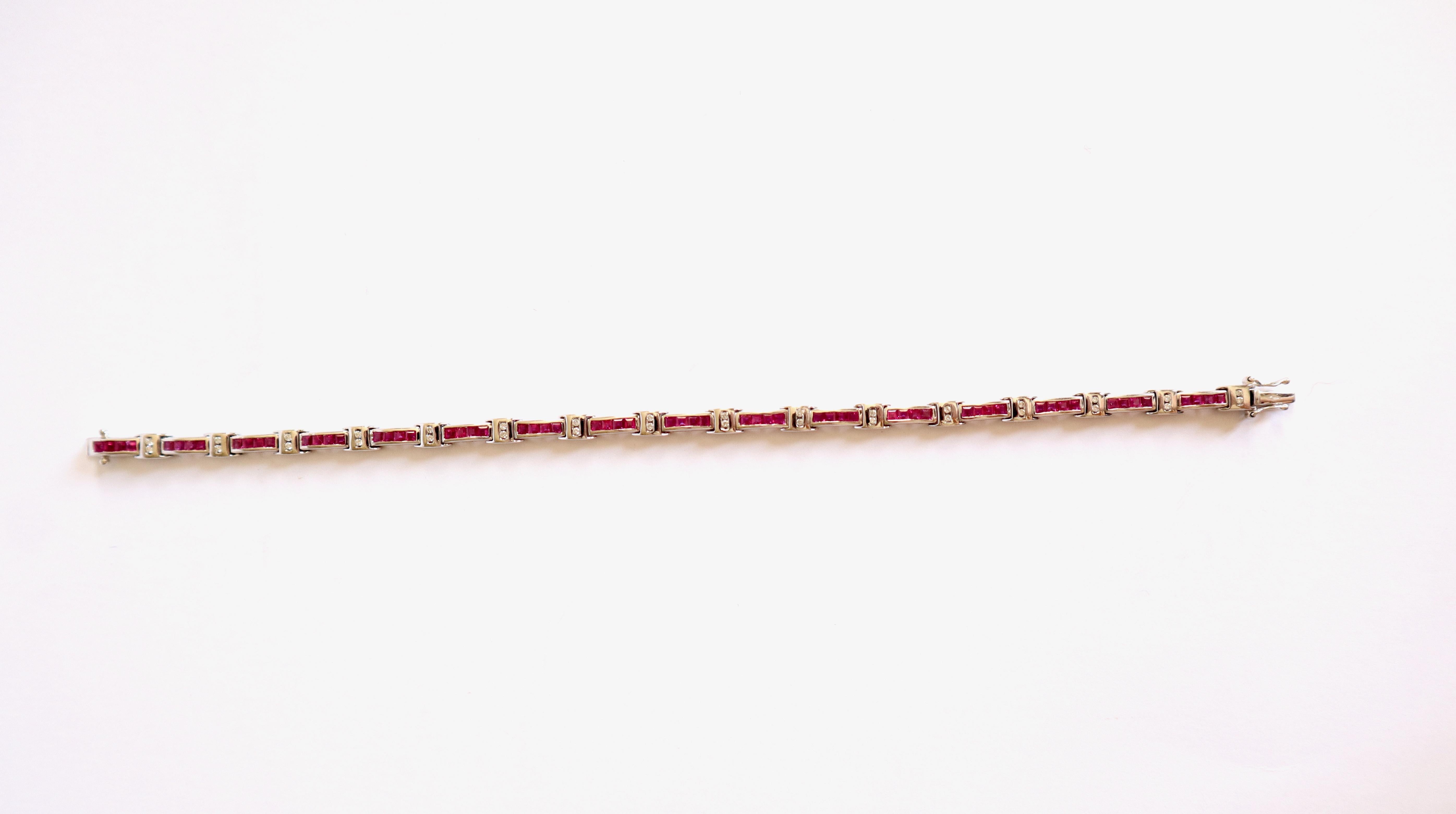 Set of Three line bracelets:
- Bracelet in 18-carat white gold, rubies and diamonds composed of 16 motifs of 4 calibrated rail-set rubies for a total weight of 3.28 carats alternating with 16 motifs of 2 diamonds for a total weight of 0.19