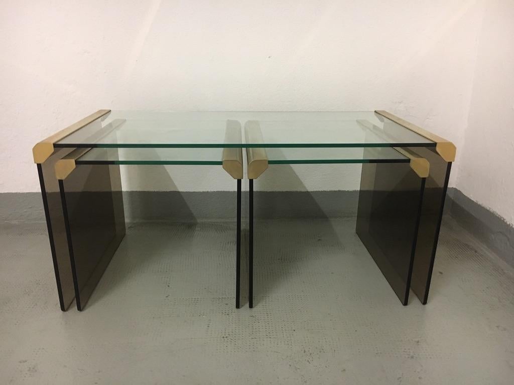 Set of 3 brass and smoked glass nesting tables by Pierangelo Galotti for Galotti & Radice, Italy, circa 1970s.