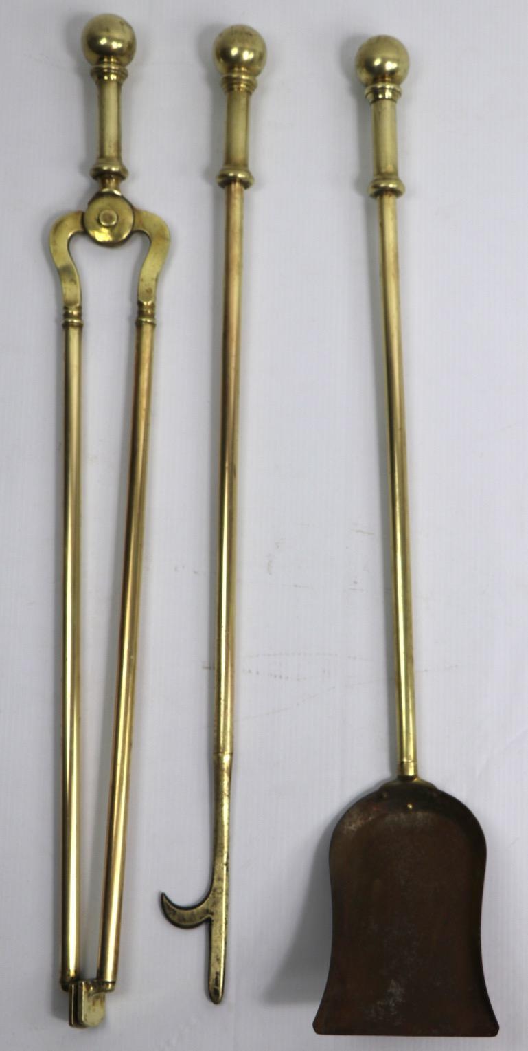 Nice quality solid brass fire place tool set to include poker, shovel and tongs. The handles have a gutsy brass ball top finial giving the tool a solid and substantial feel when used. We believe this set was manufactured by Wm. H. Jackson, but they