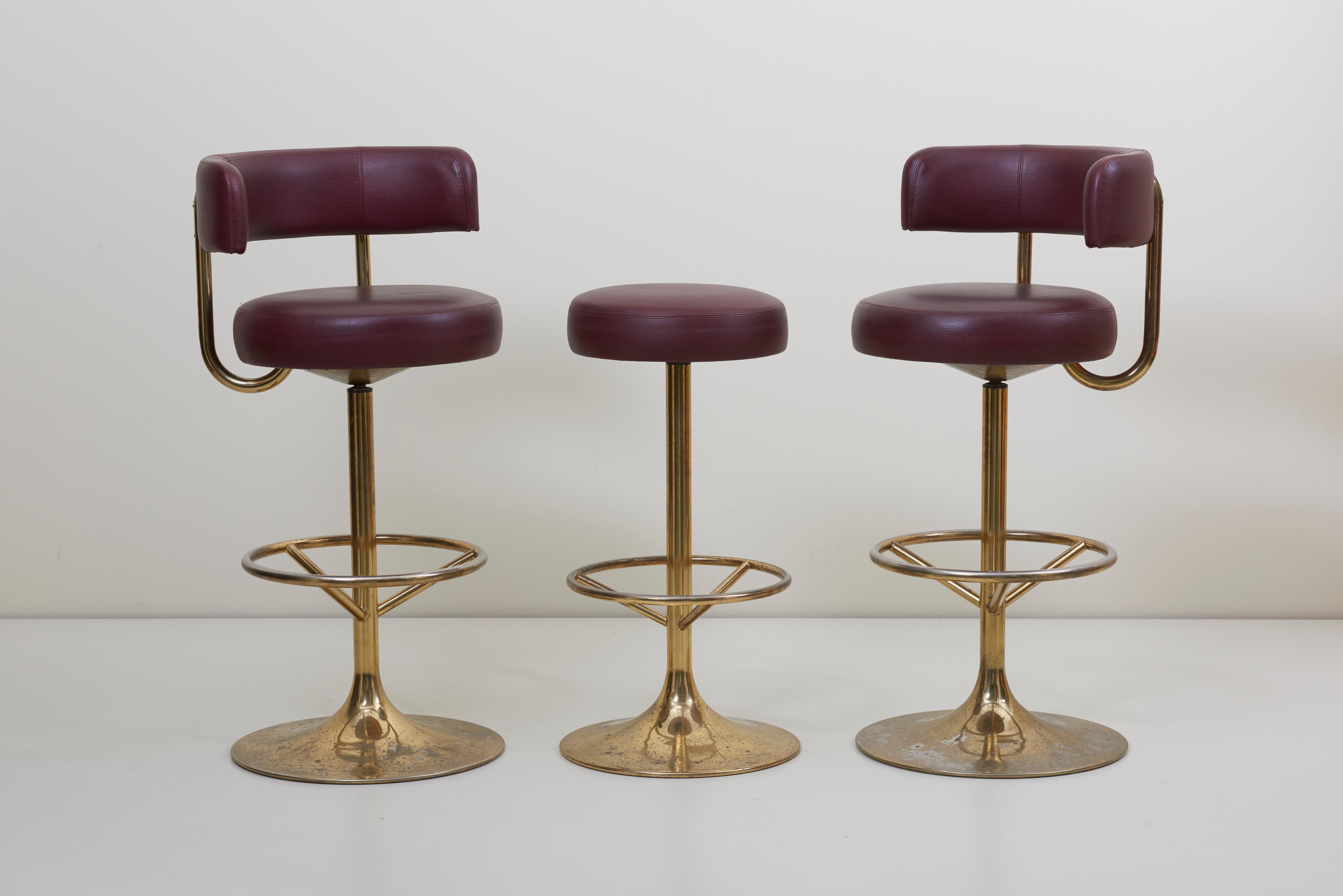 Wonderful set of gold-plated and red-brown faux leather Jupiter and Venus barstools. The stools are rotatable and very comfortable. They are designed by Börje Johansson and produced by Johansson Design in Markaryd, Sweden and labeled.