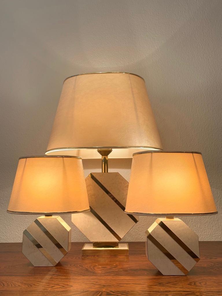Set of 3 brass and lacquered wood, octogonal bases with brass inlays table lamps, ca. late 1970's
Original paper shades with brass trims
Very good condition
Mother with babies...
Measures: Mother: H 65 x L 45 x D 28 cm
Babies: H 33 x L 25 x D