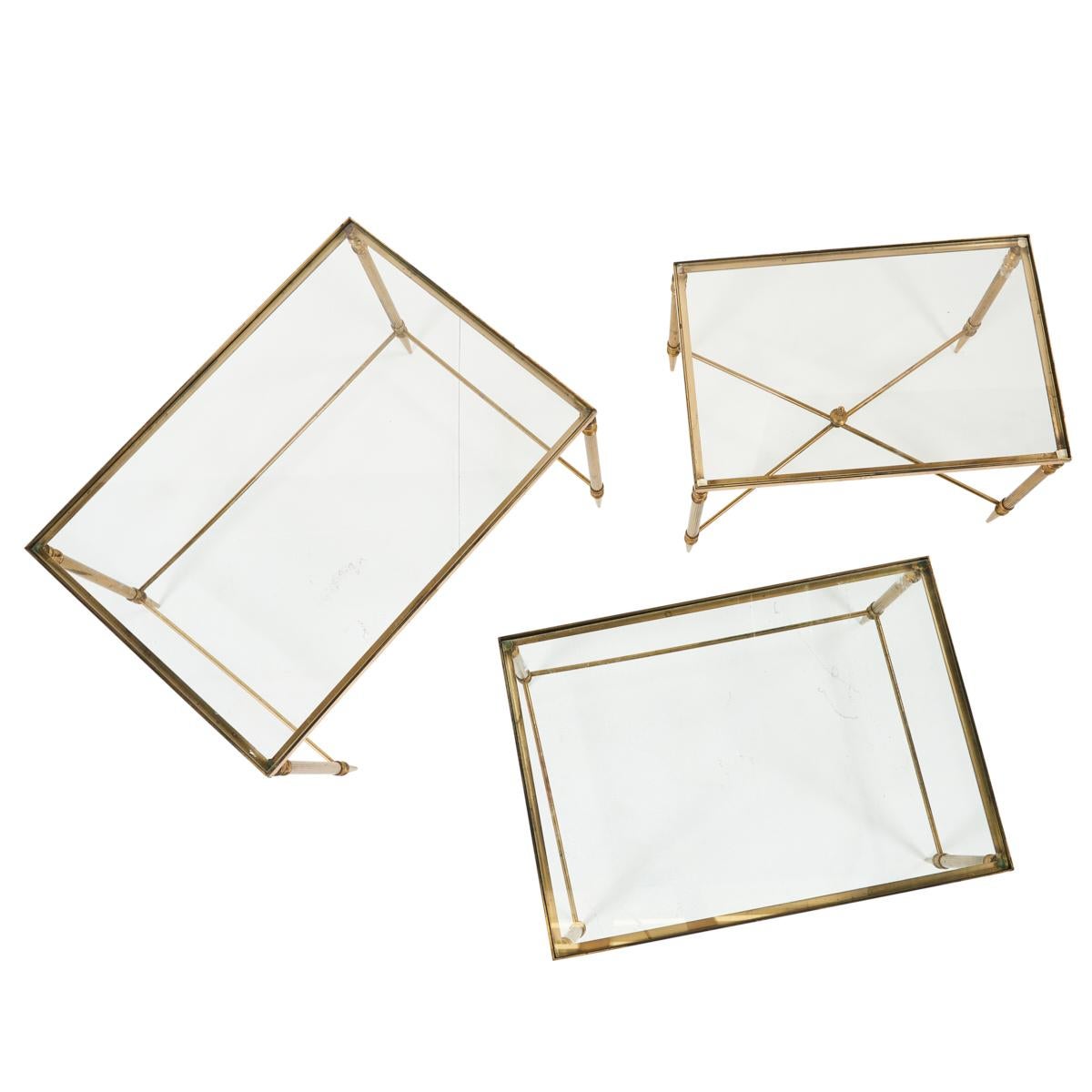 A wonderful vintage find from France, this set of nesting tables is timeless, elegant and infinitely useful. Their delicate silhouettes make them remarkably versatile and easy to place in any room that calls for a flash of brass, glass and glamour. 
