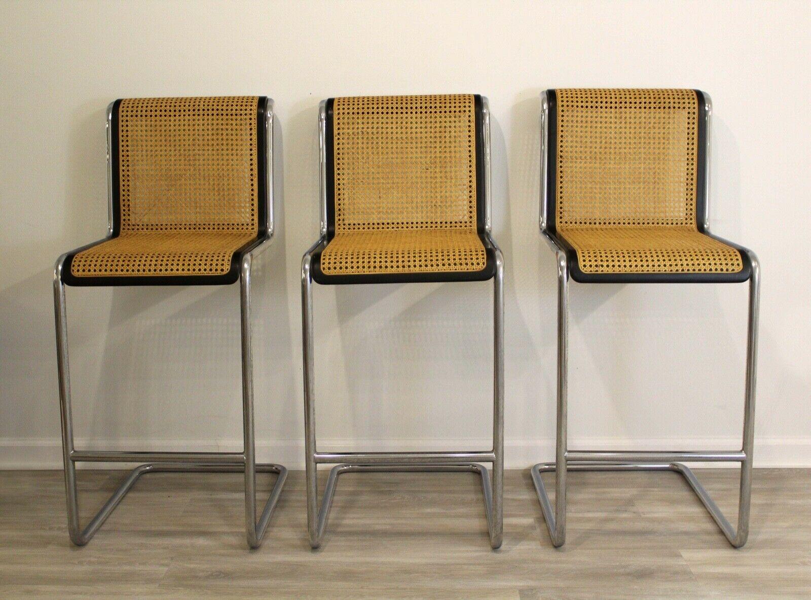 From Le Shoppe Too in Michigan comes this set of three iconic Marcel Breuer Cesca Bar stools. Italian made in the 1970's, this design has become a classic representation of both Knoll and Breuer. Detailed with a caned back and seat as well as gentle