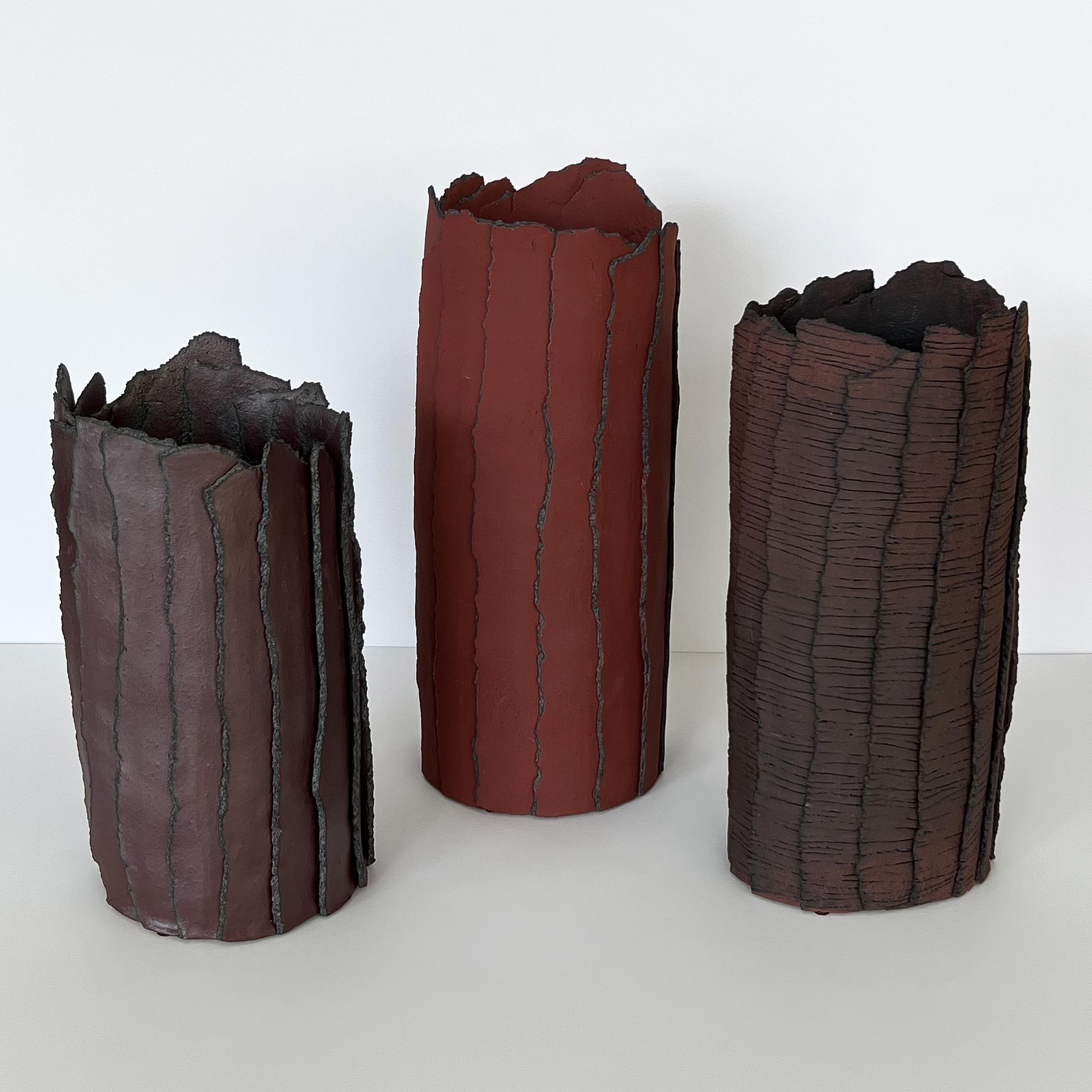 Set of three Brutalist abstract ceramic cylinder vases / sculptures with texture, Belgium circa Late 20th Century. Slab style cylindrical shaped vase sculptures with abstract organic bark motif. Layered vertical slab construction with glazed surface
