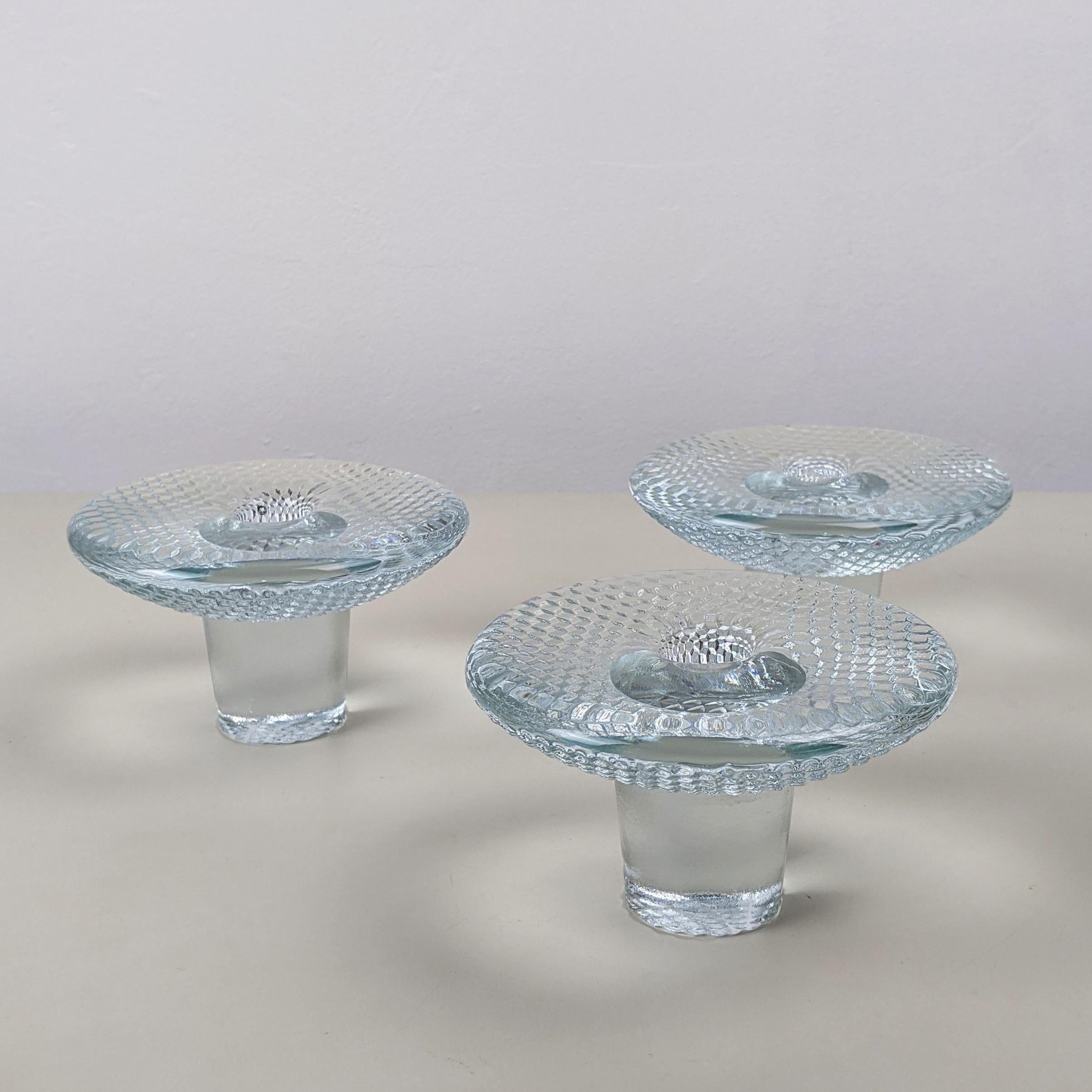 Markku Salo (attributed) for IIttala, c. 1970
Candle holders, set of 3

Clear pressed glass
Excellent condition

Dimensions, each approx..:
Height 7.5 cm
Diam. 12.5cm
Weight 783g.