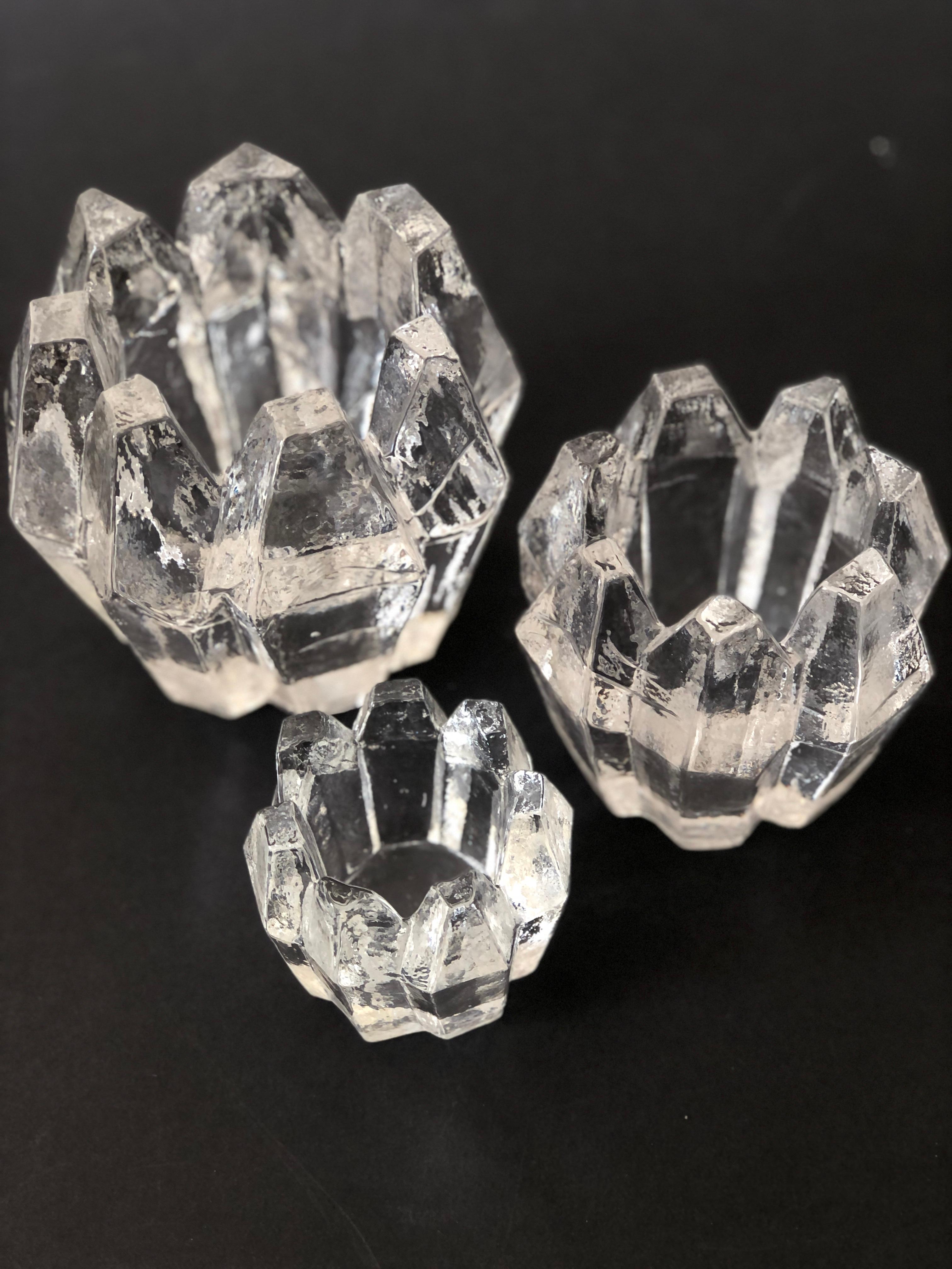 Set of 3 Candle Holders in full Chrystal Glass by Christer Sjögren for Lindshammars Glasbruk, Sweden. The two larger ones are signed by the artist, Christer Sjögren. Fitting for tea lights. These Brutalist 1960s candle holders came in three sizes