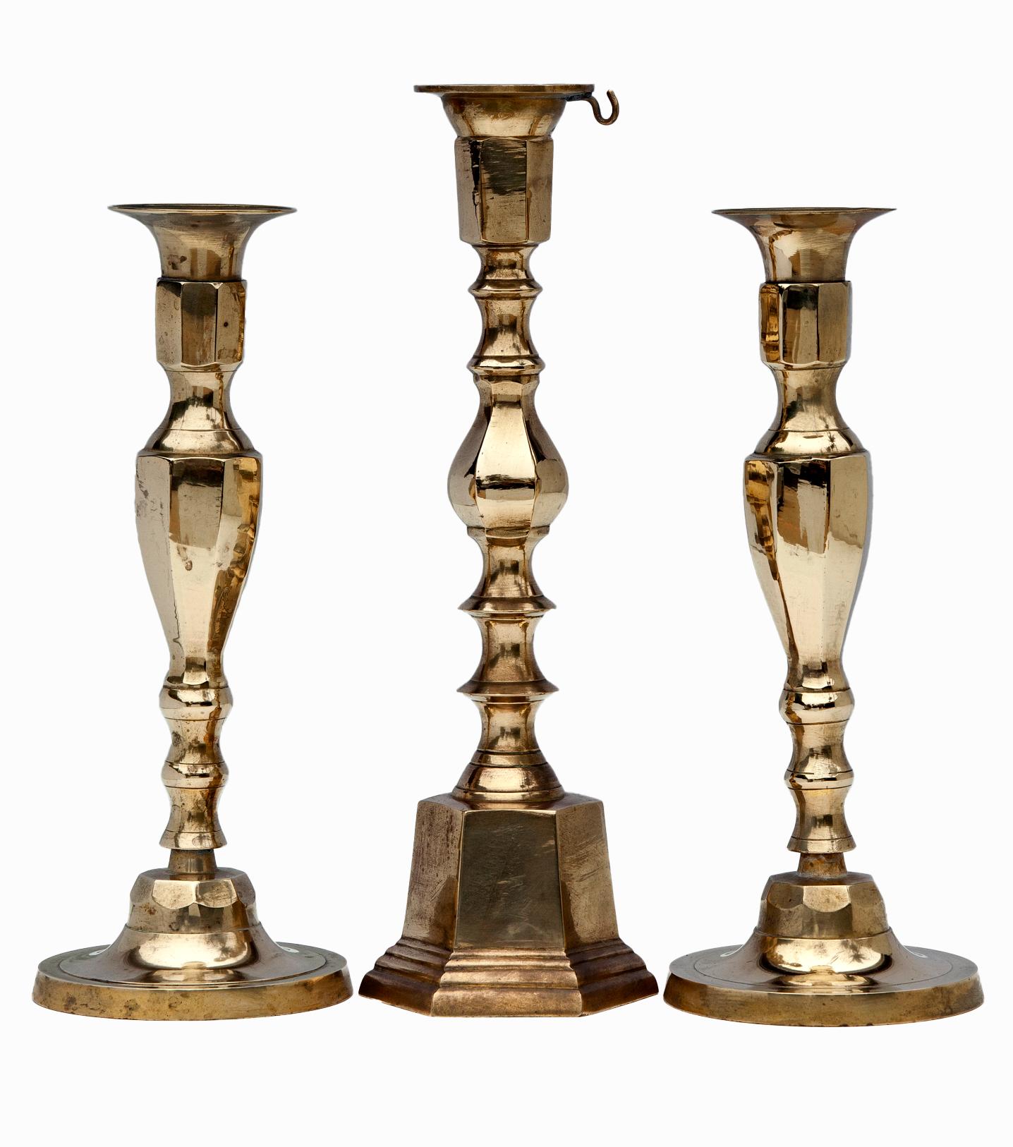 Imagine a time when dining by candlelight was a daily occurrence.
Beautiful candlesticks with classic Georgian style.
One of which has a hook for a snuffer, all three have a channeled design.
The point that brings this trio together.
They are